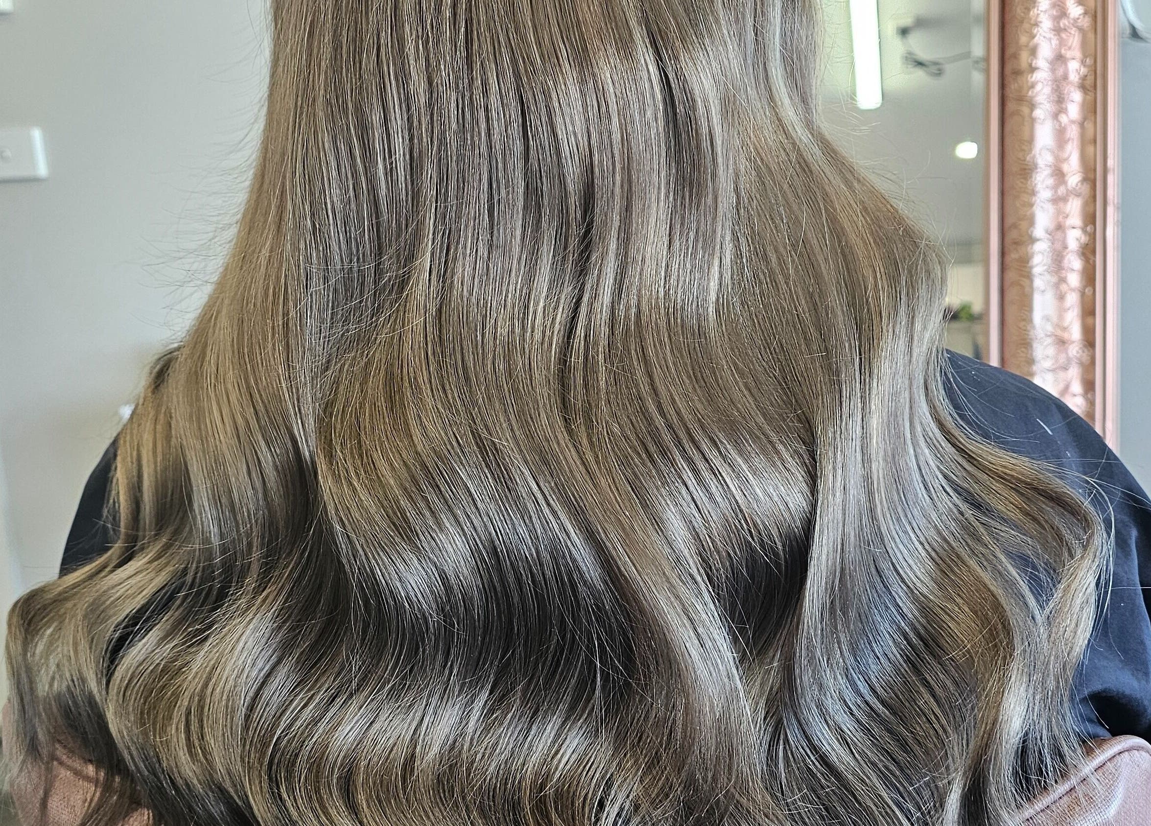 Smooth, silky hairstyle at Tease by Jess, Mildura, Victoria, AU, showcasing vibrant, glossy waves.