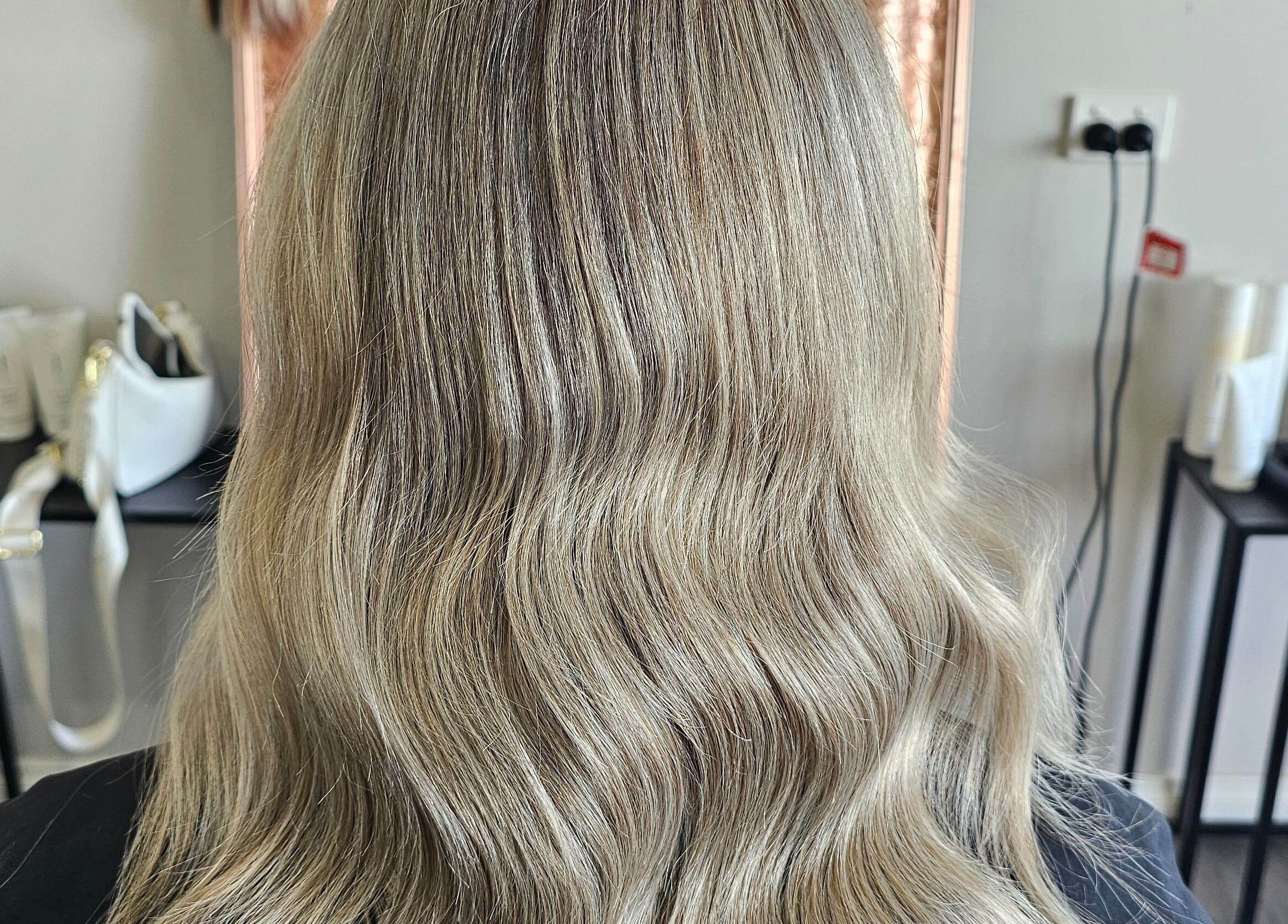 Elegant blonde waves styled at Tease by Jess, Mildura, Victoria, AU. Shimmering, wavy hair catching natural light.