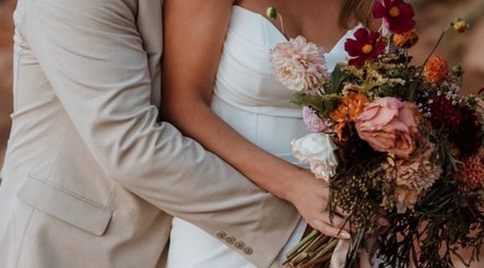 Couple embracing with a bouquet at Meg You Glow, Heber City, Utah, US.