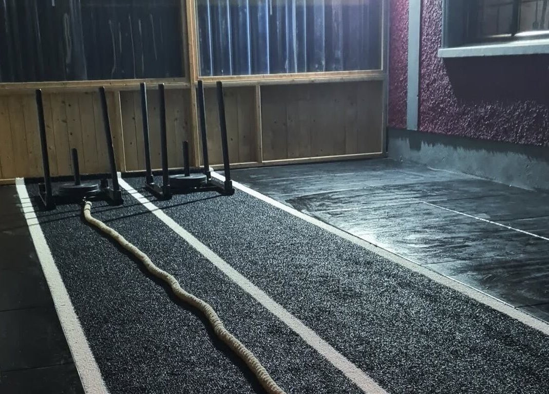 Training area at Elevate Gym + Athlete Recovery, Clogher, Northern Ireland with sled and rope equipment.