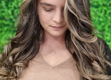Woman with elegant curls at Hair Aroma, Pretoria, Gauteng, ZA.