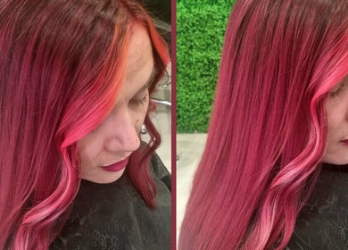 Close-up of vibrant pink and red curls at Hair Aroma, Pretoria, Gauteng, ZA, showcasing expert color blending.