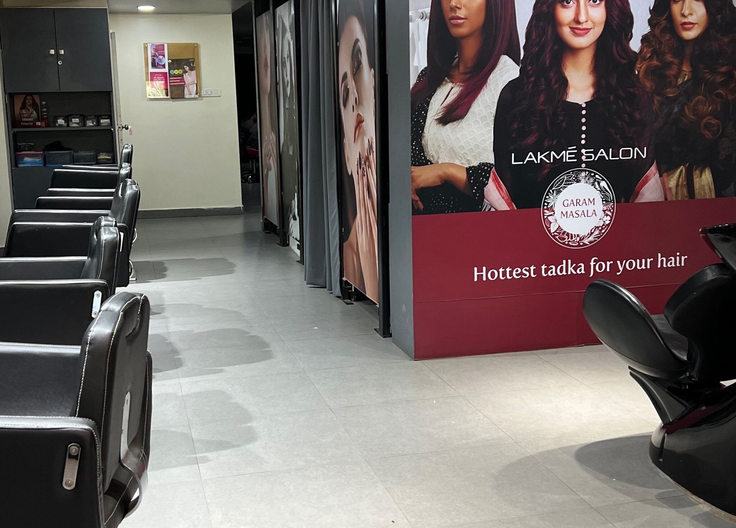 Interior of Lakme Salon Kompally in Hyderabad, Telangana, IN showcasing chic salon chairs and stylish decor.