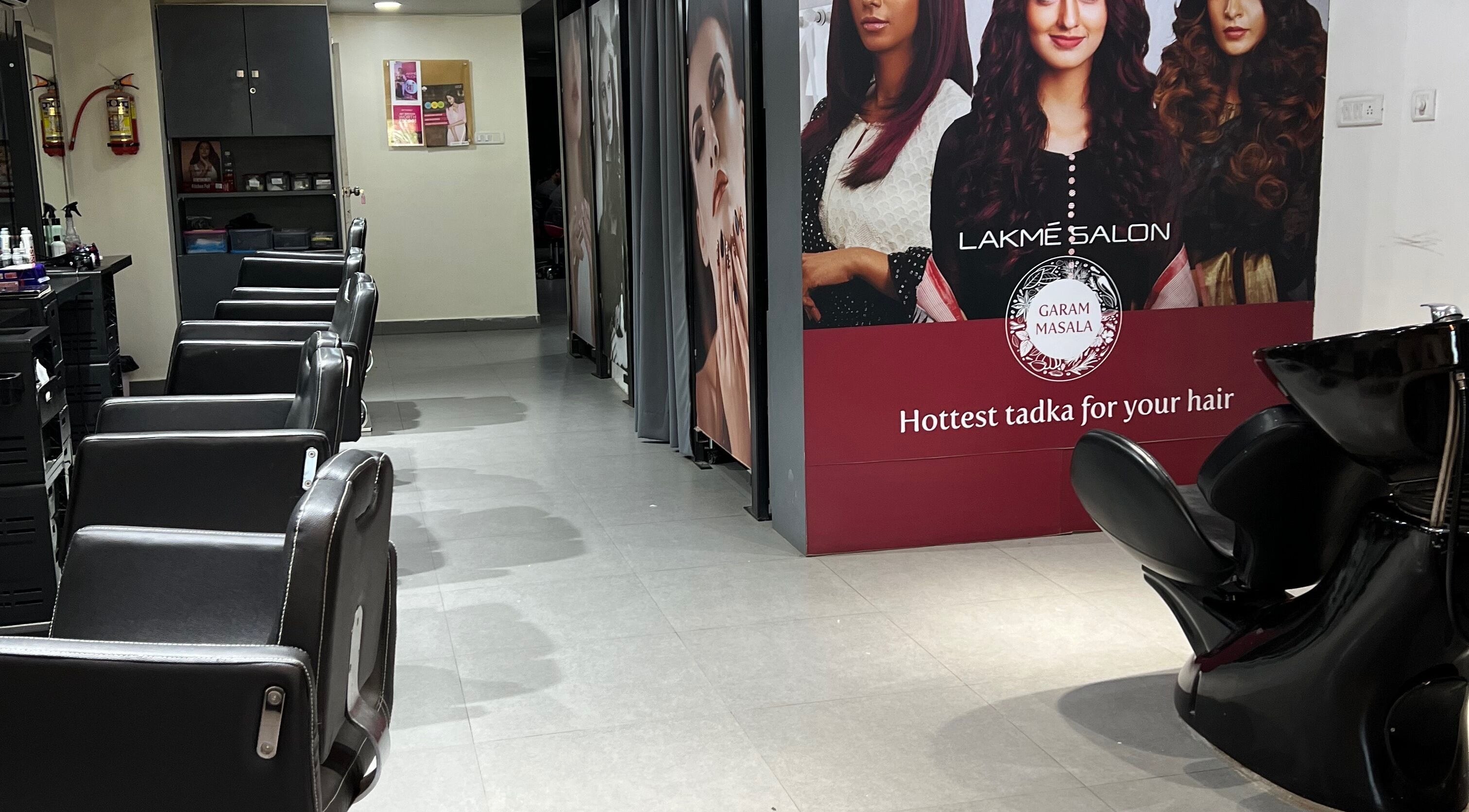 Interior of Lakme Salon Kompally in Hyderabad, Telangana, IN showcasing chic salon chairs and stylish decor.
