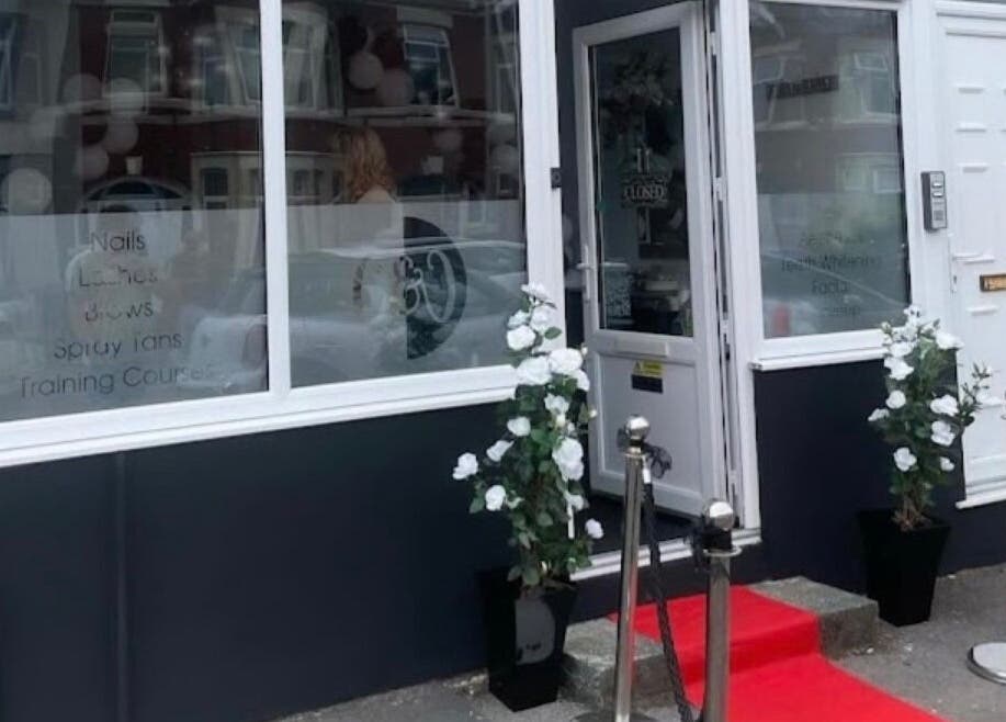 Front entrance of The Glow Up in Blackpool, England, GB with red carpet and floral decor.