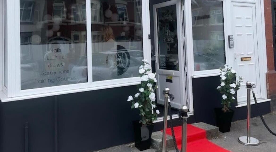 Front entrance of The Glow Up in Blackpool, England, GB with red carpet and floral decor.