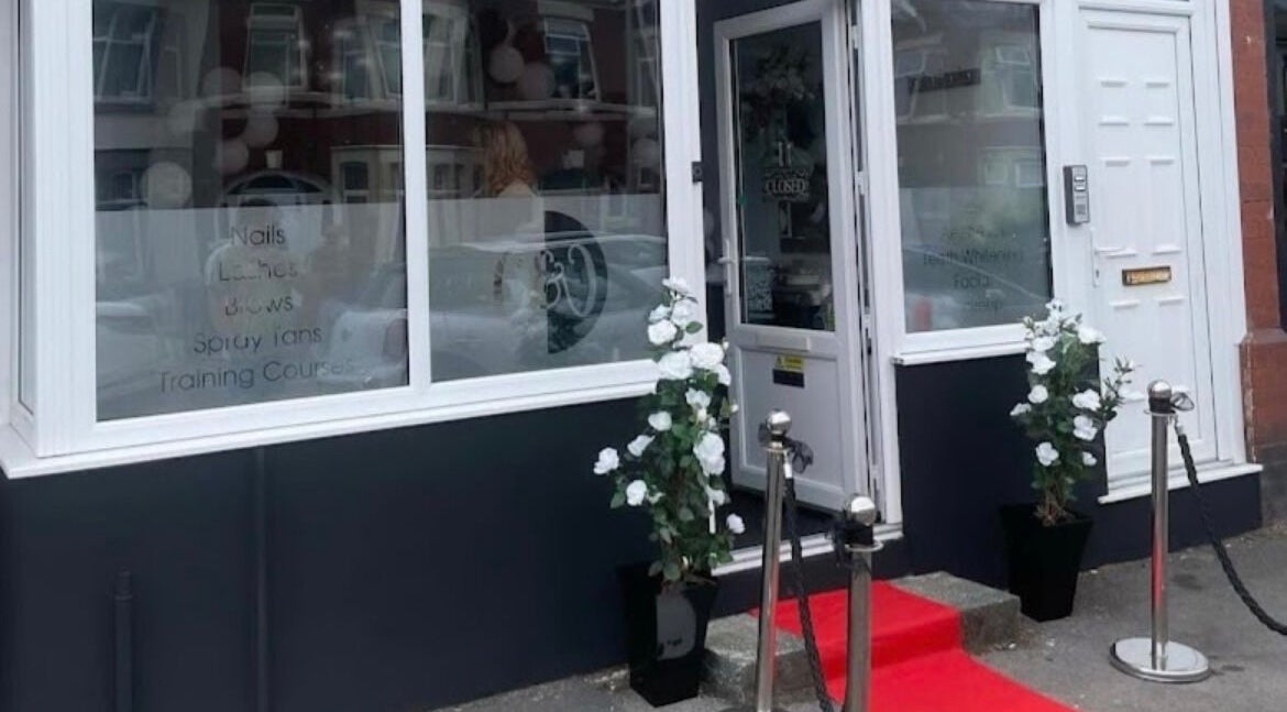 Front entrance of The Glow Up in Blackpool, England, GB with red carpet and floral decor.