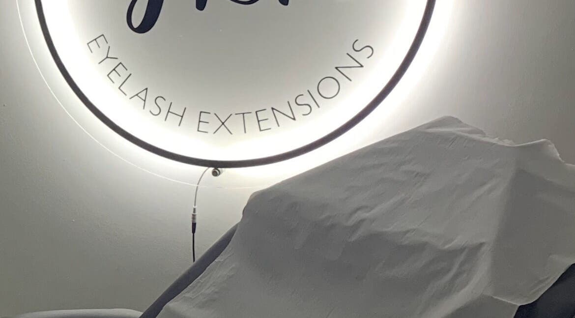 JLR Lashes venue in Port Seton, Scotland featuring a cozy treatment chair under illuminated signage.