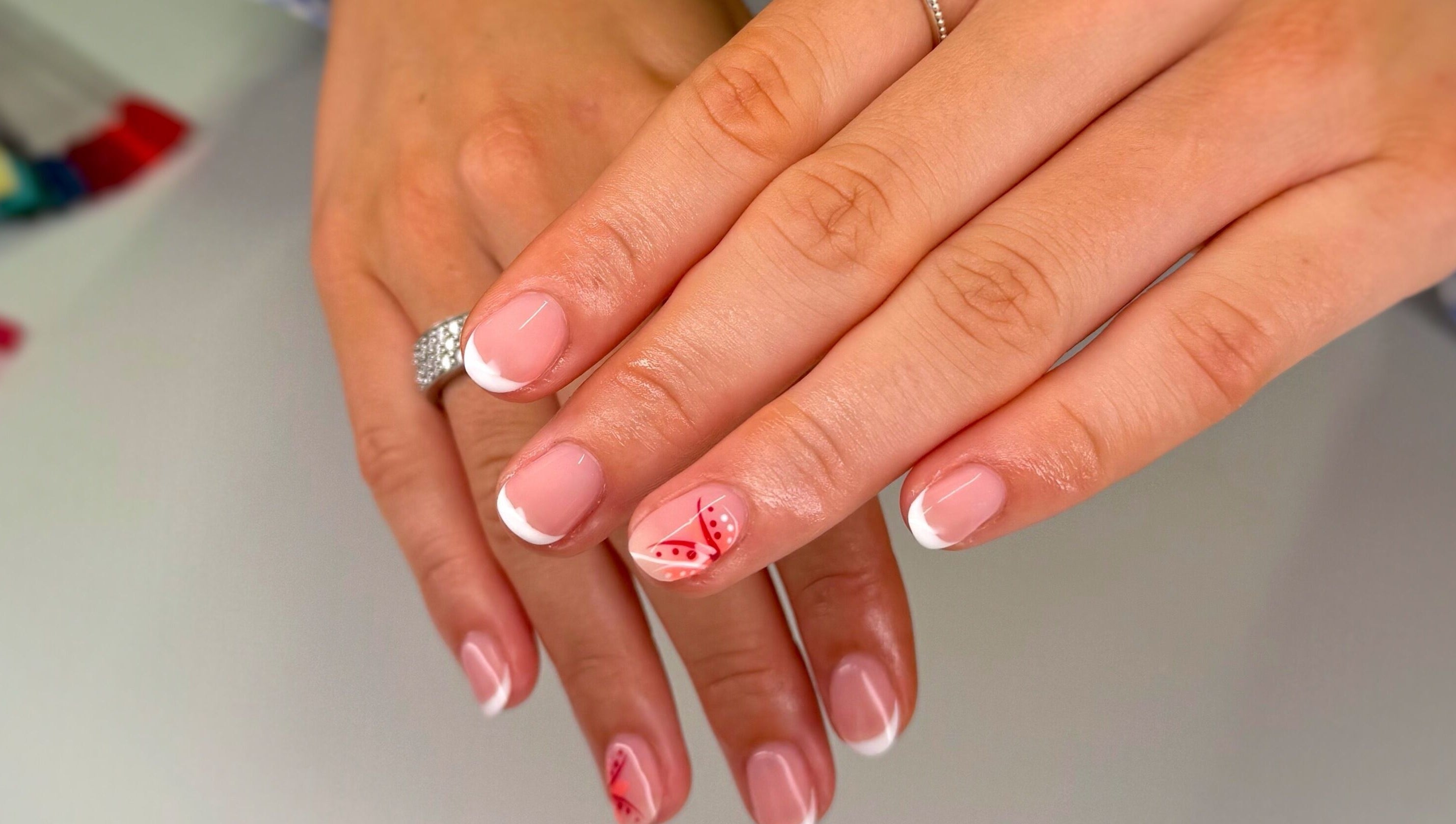 Stylish French manicure with floral design at Serenity Studio, Great Canfield, England, GB.