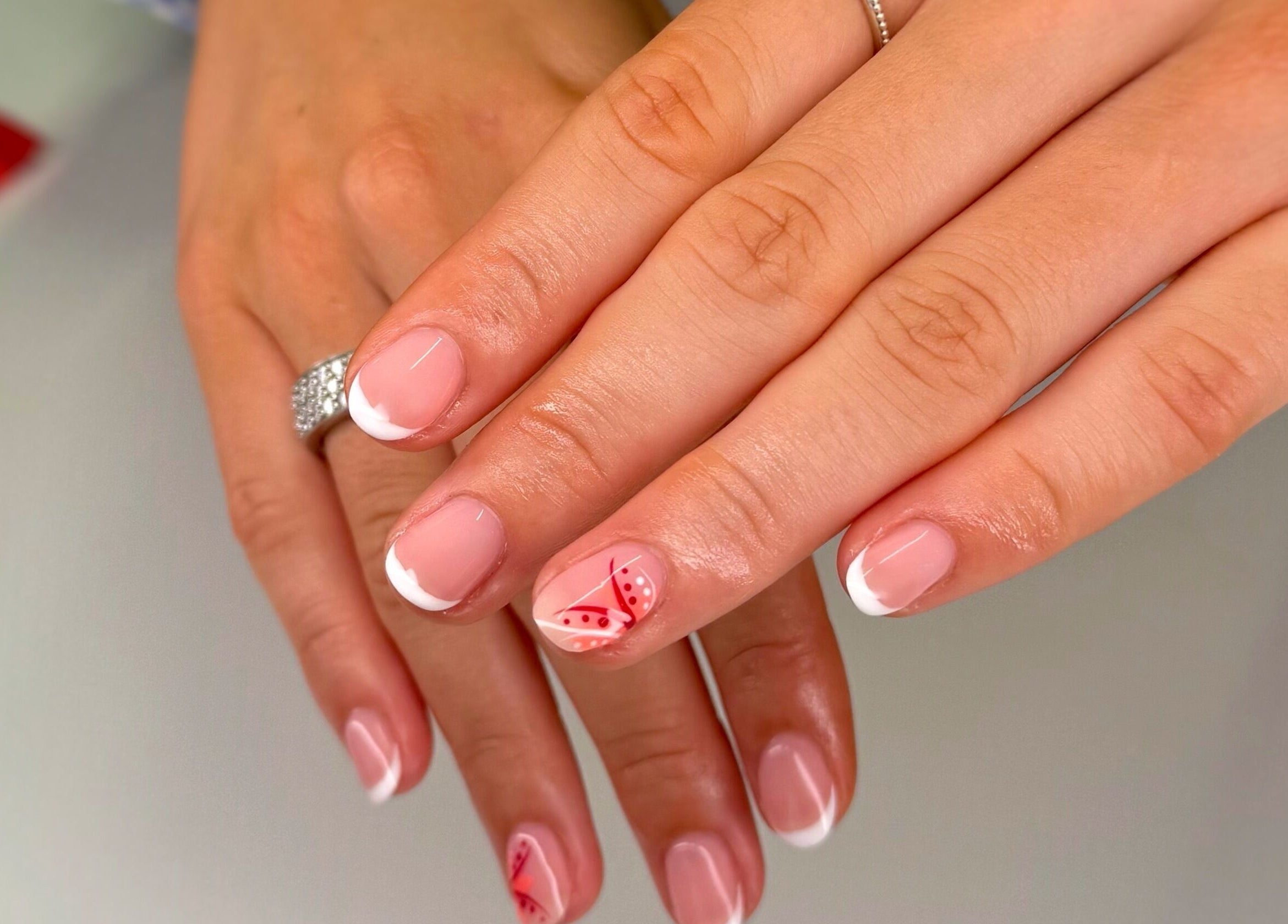 Stylish French manicure with floral design at Serenity Studio, Great Canfield, England, GB.