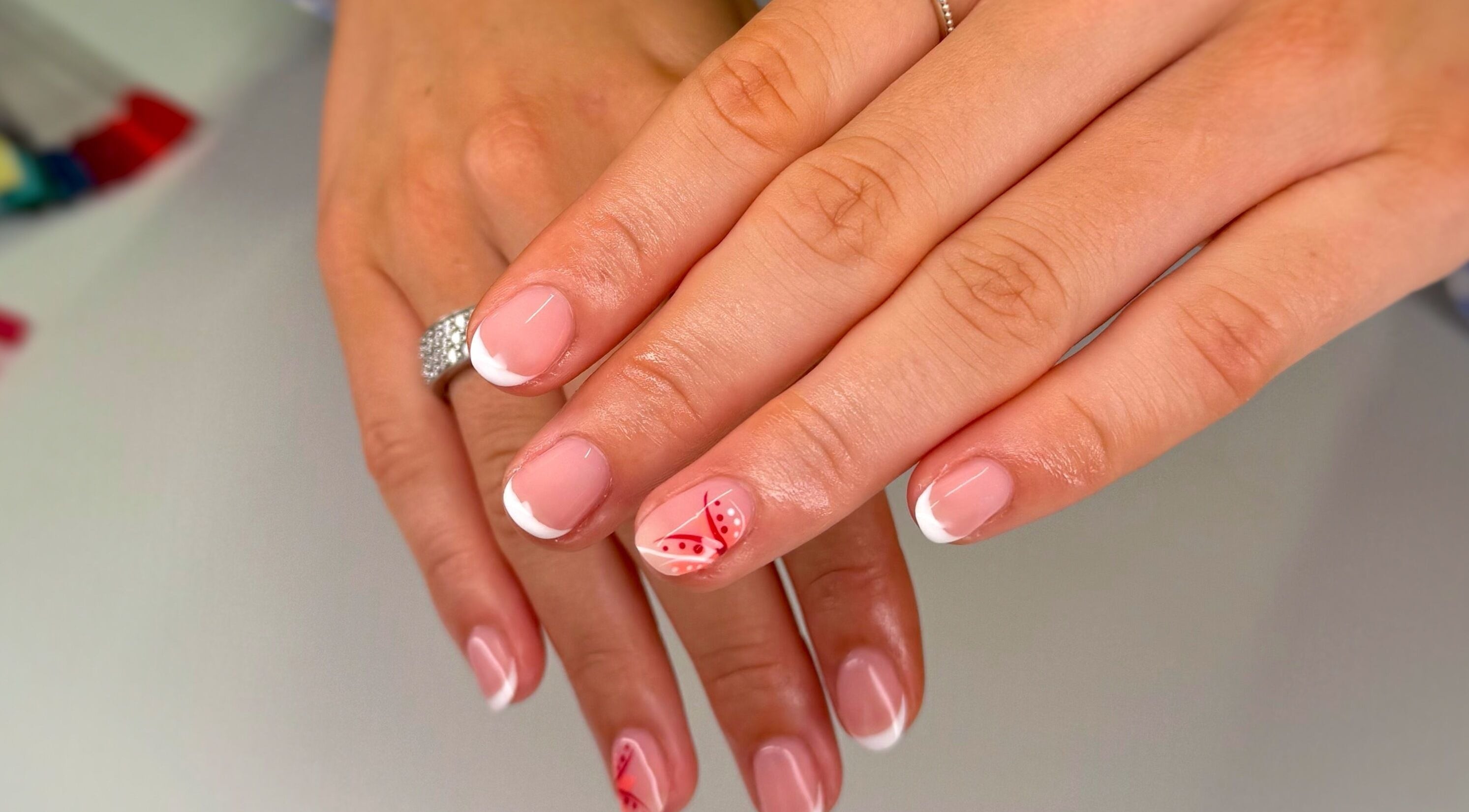 Stylish French manicure with floral design at Serenity Studio, Great Canfield, England, GB.