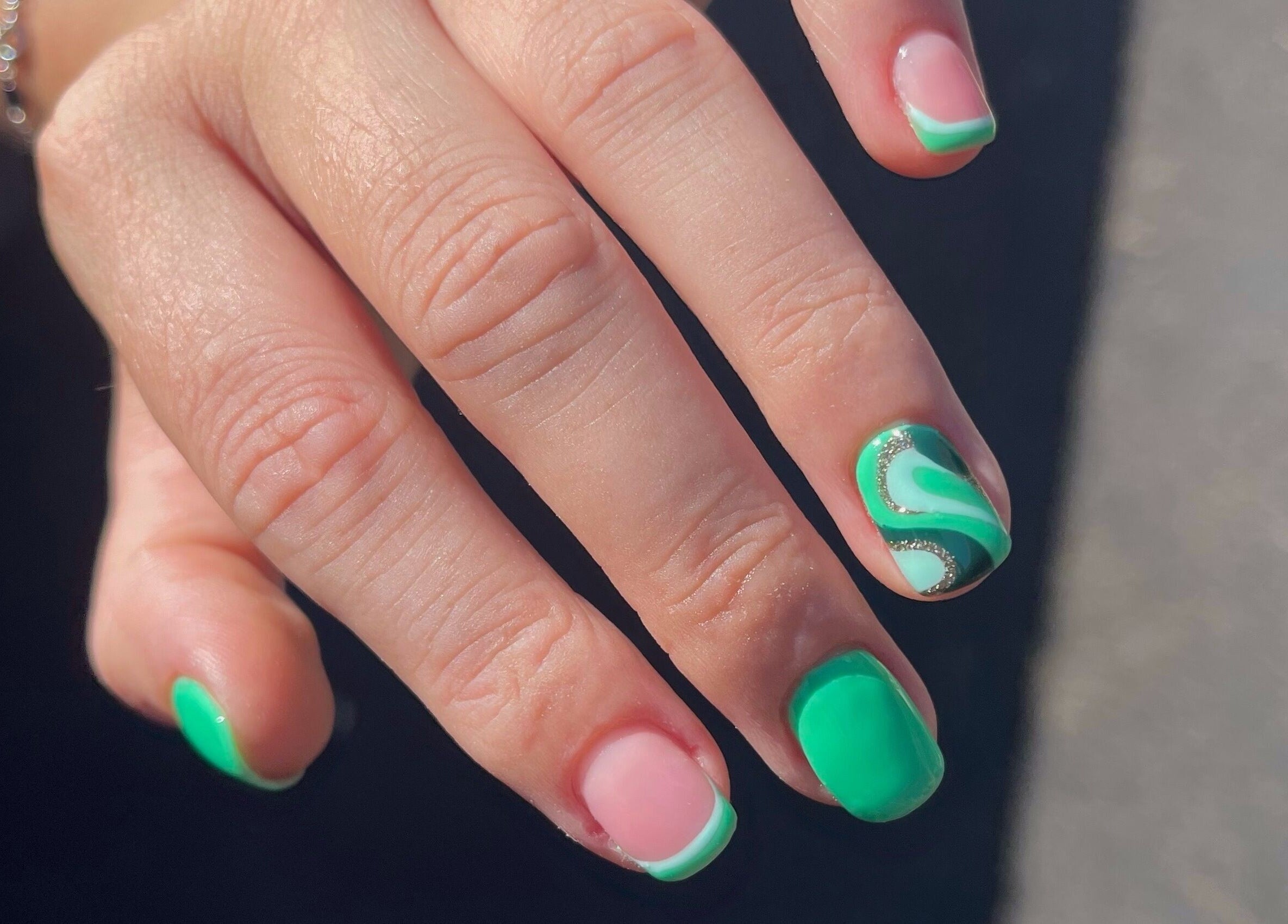 Stylish green and pink nail art at Serenity Studio, Great Canfield, England, GB enhancing fashion statement.