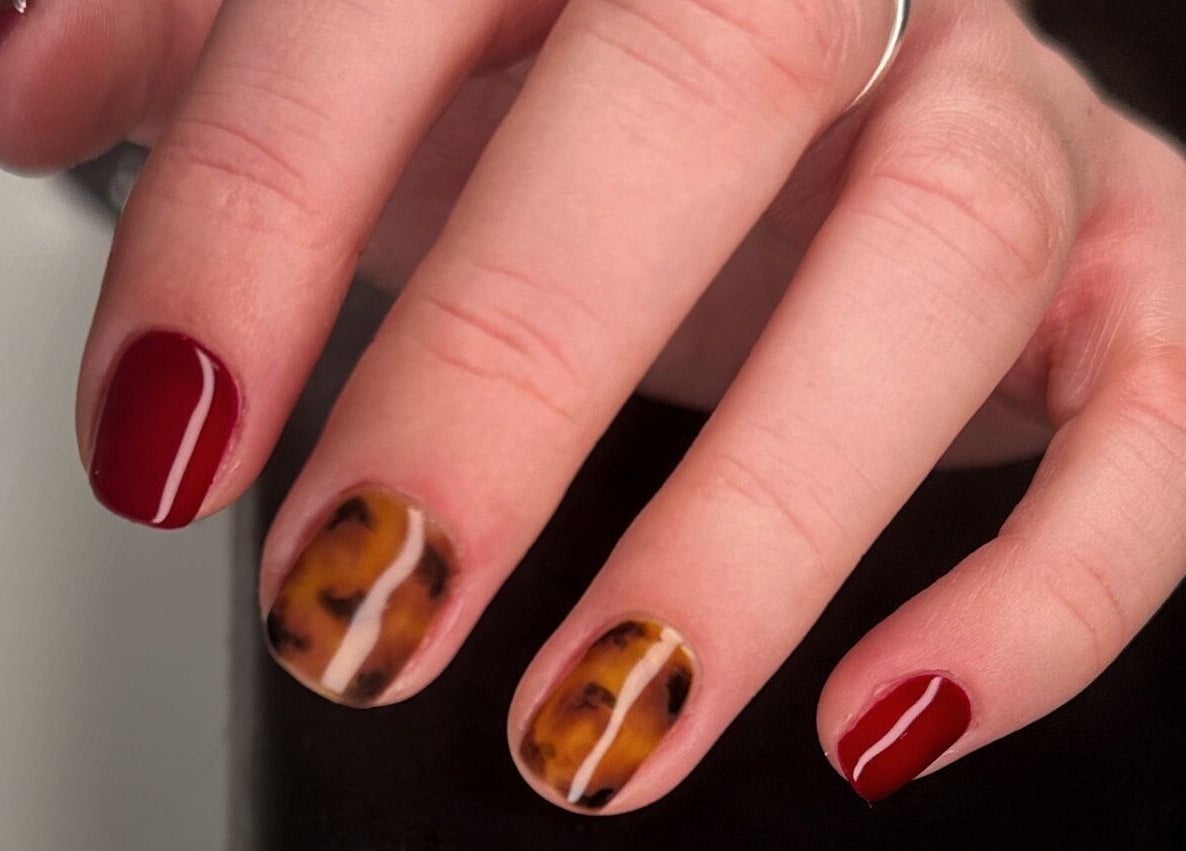 Stylish tortoiseshell and red nail art at Serenity Studio, Great Canfield, England, GB.