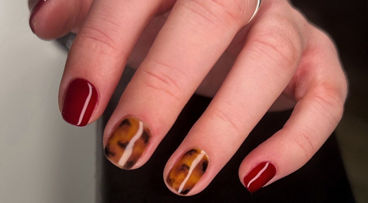 Stylish tortoiseshell and red nail art at Serenity Studio, Great Canfield, England, GB.