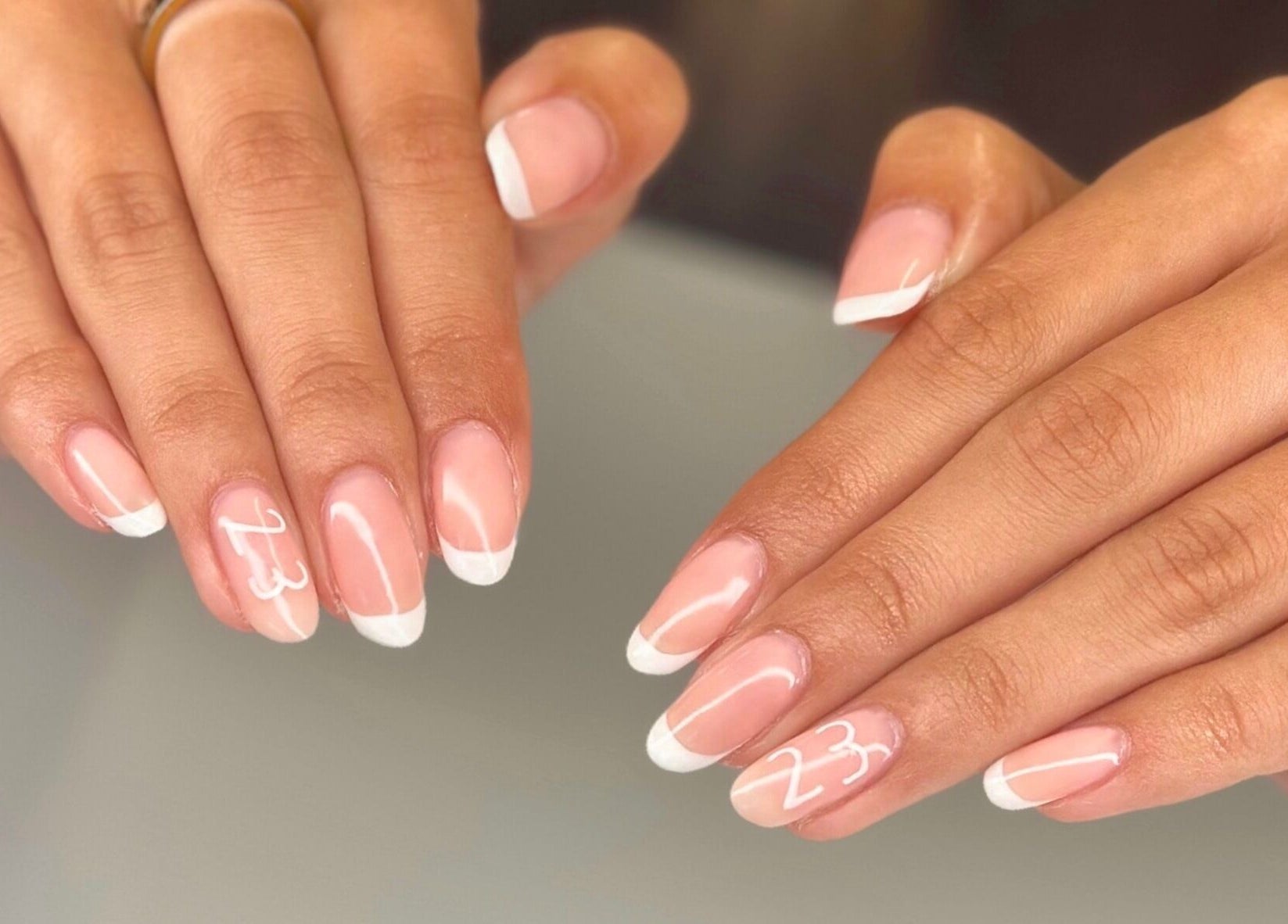 Stylish French manicure with '23' design at Serenity Studio, Great Canfield, England, GB.