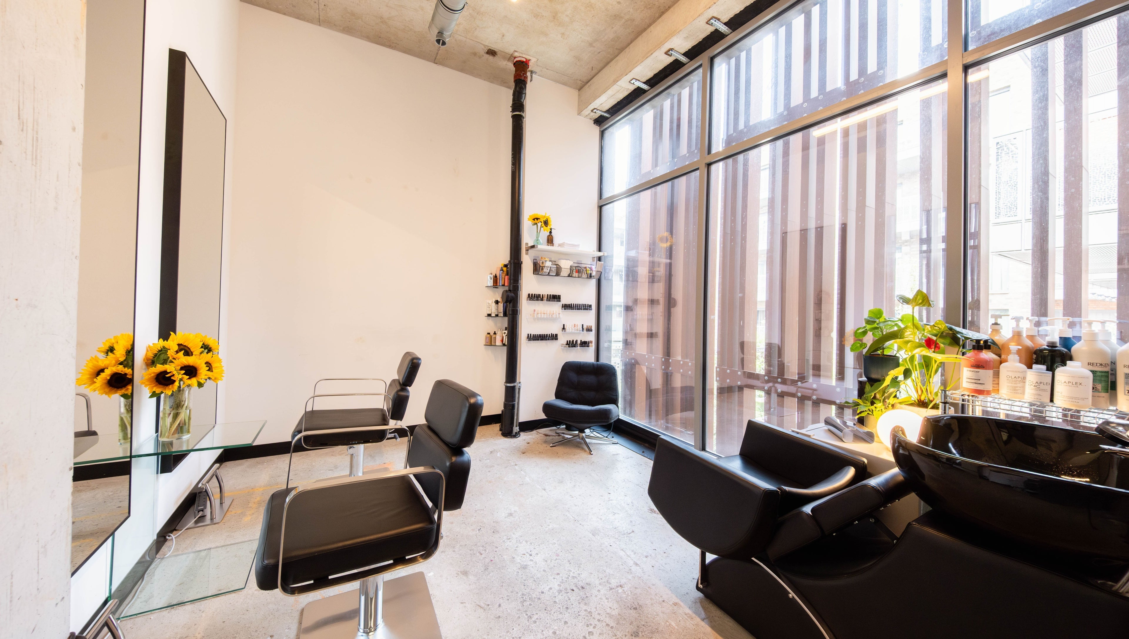 Modern salon setup at SPACE5, London, GB with sleek chairs and bright decor.