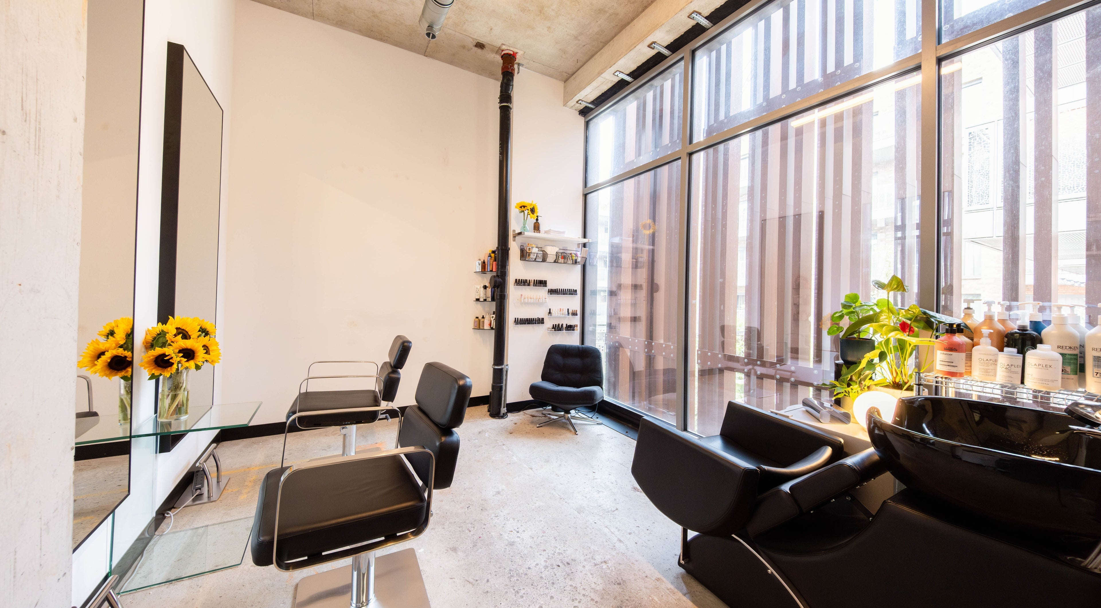 Modern salon setup at SPACE5, London, GB with sleek chairs and bright decor.