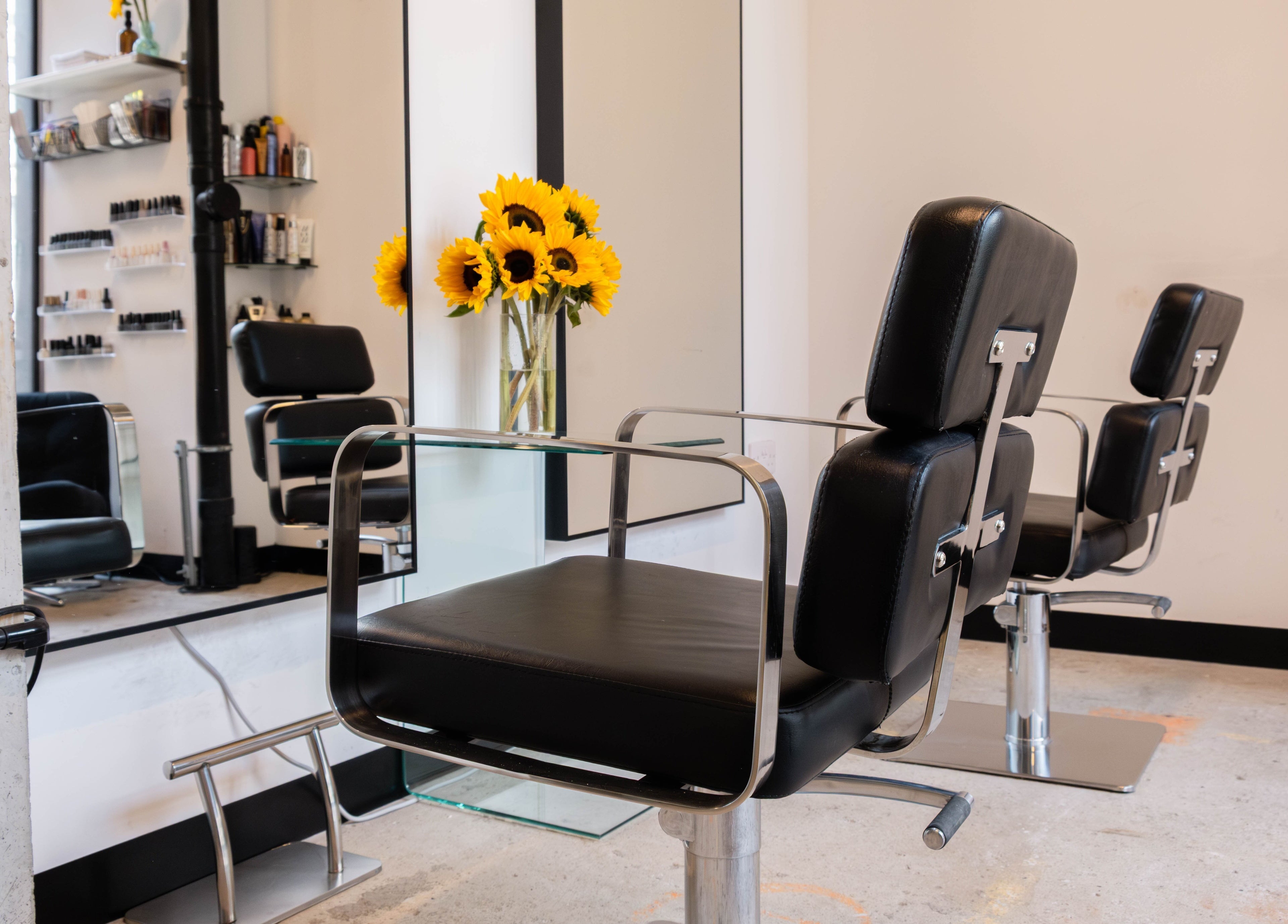 Modern salon chair and sunflowers at SPACE5, London, GB enhance a stylish grooming experience.