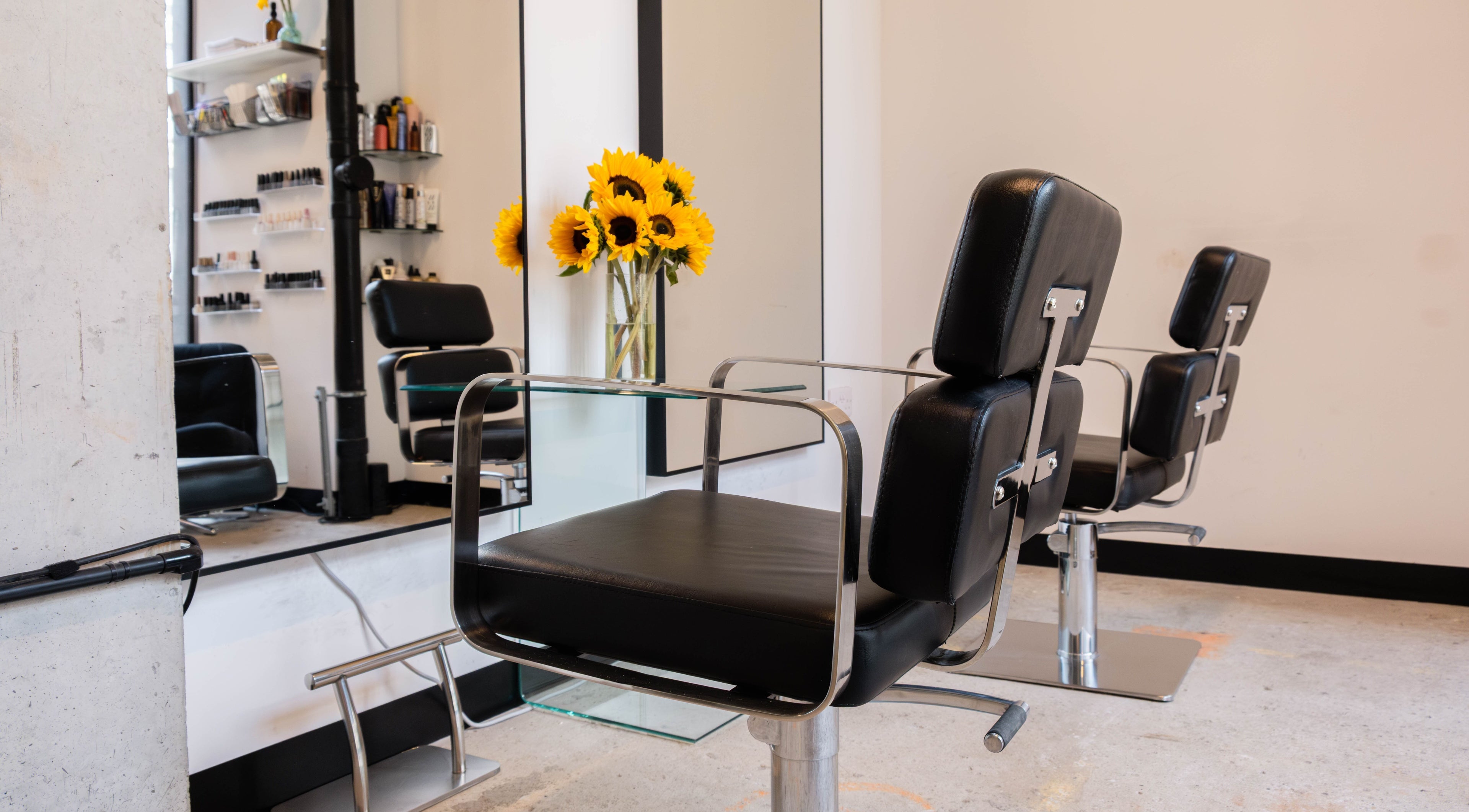 Modern salon chair and sunflowers at SPACE5, London, GB enhance a stylish grooming experience.