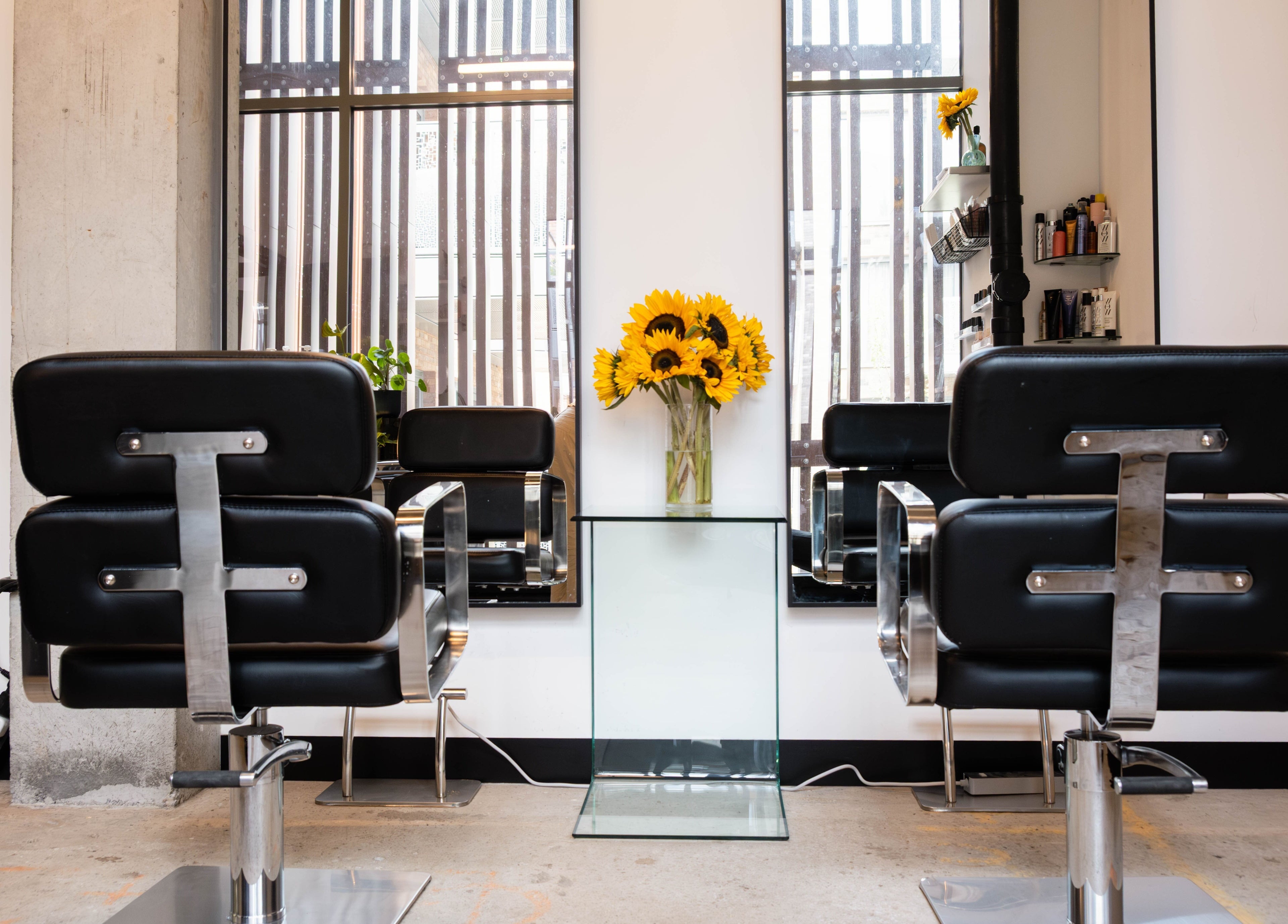 Modern salon chairs and sunflowers at SPACE5, London, GB, create an inviting beauty space.