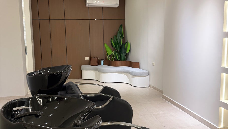 Modern shampoo area with stylish black basins at Curlz Beauty Center - Irbid, Irbid Governorate, JO.