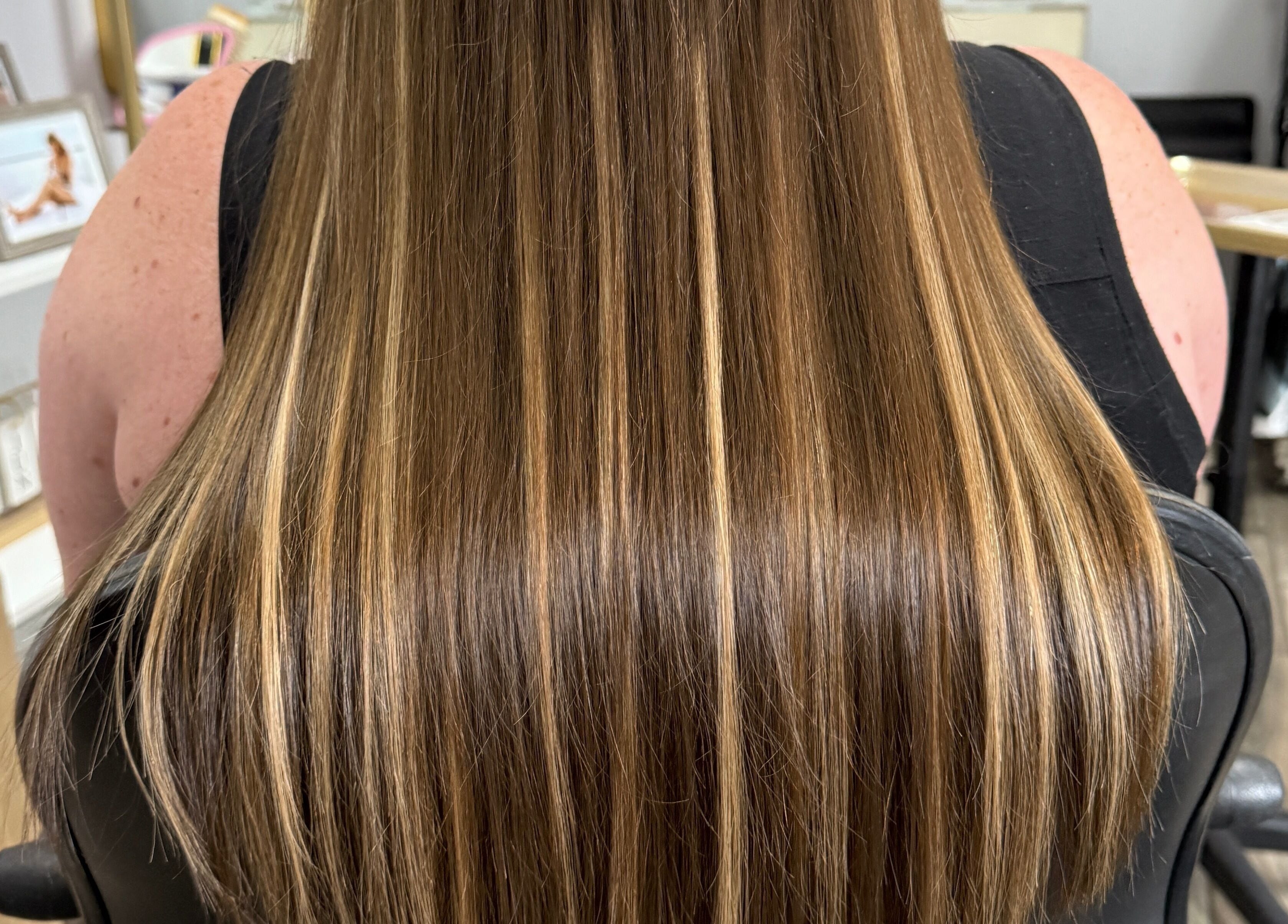 Sleek brown hair extensions at Orillia & Area Luxury Extension Beauty Bar, Orillia, Ontario, CA.