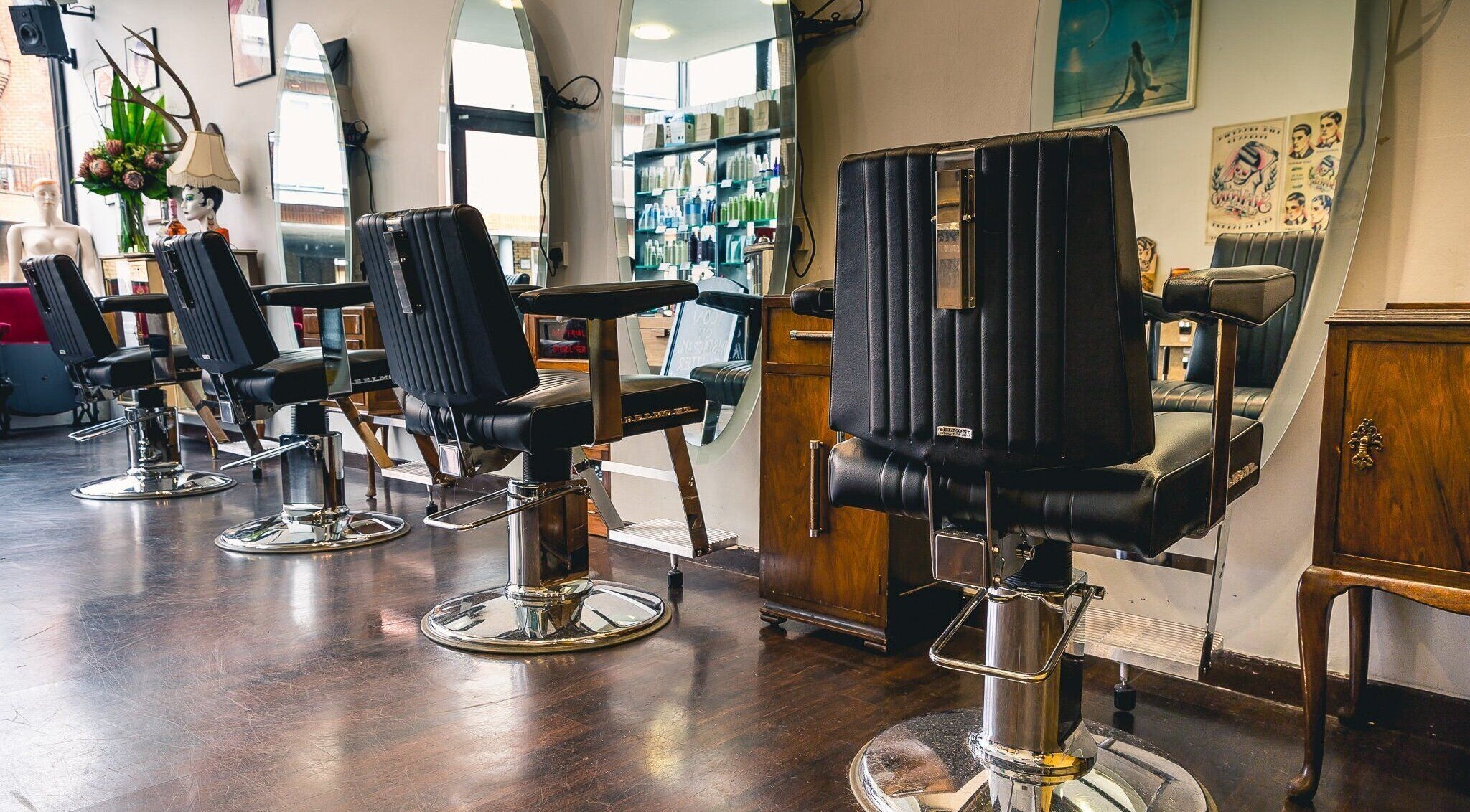 Modern salon chairs at Icon Hairdressing, Kingston upon Thames, England, GB reflect stylish elegance.