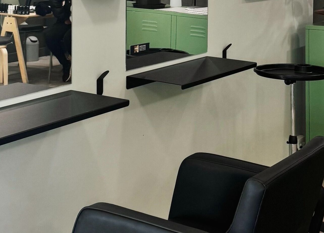 Modern styling area in Birdhaven Studio, Johannesburg, Gauteng, ZA with sleek black chair and minimalist design.