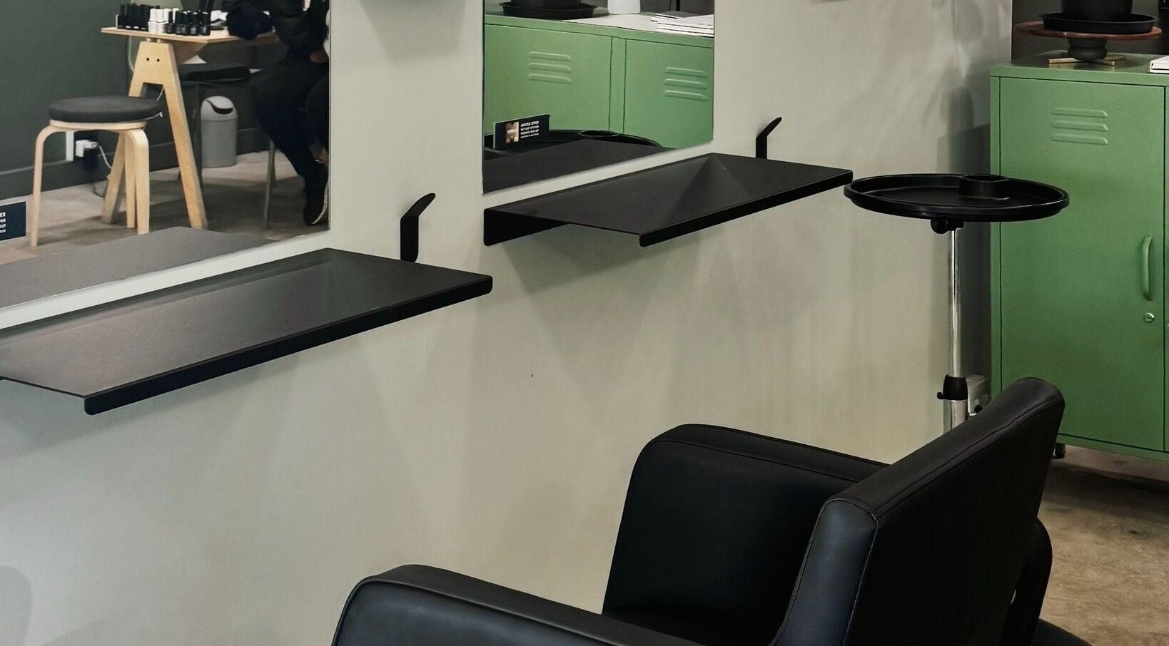 Modern styling area in Birdhaven Studio, Johannesburg, Gauteng, ZA with sleek black chair and minimalist design.