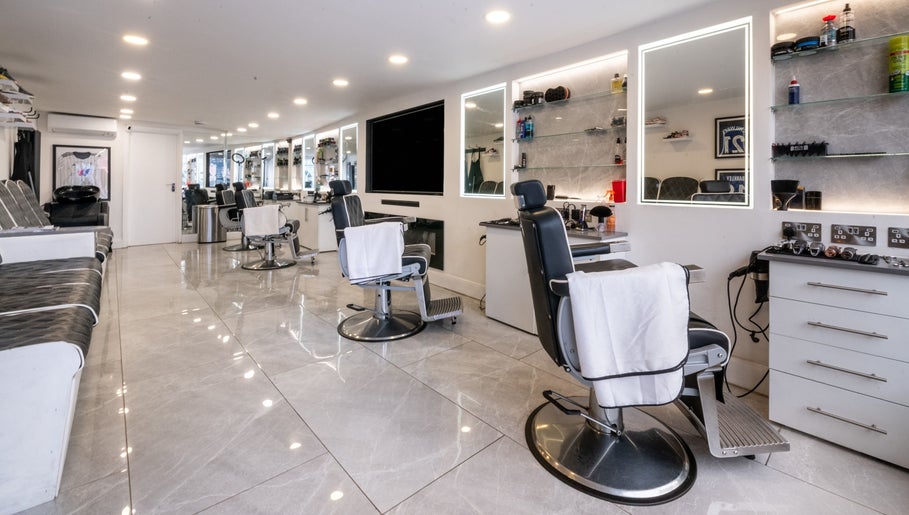 Interior of Grays Grooming For Men in Ewell, England, GB featuring modern barber chairs and mirrors.