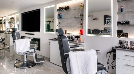 Modern barber chairs at Grays Grooming For Men, Ewell, England, GB showcasing sleek interior.