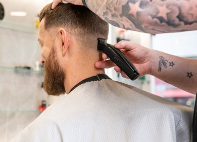 Expert barbering at Grays Grooming For Men, Ewell, England, GB. Precision trimming of a client's hair.