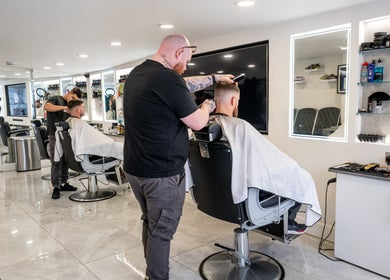 Stylish haircut in progress at Grays Grooming For Men, Ewell, England, GB. Modern barber shop ambiance.