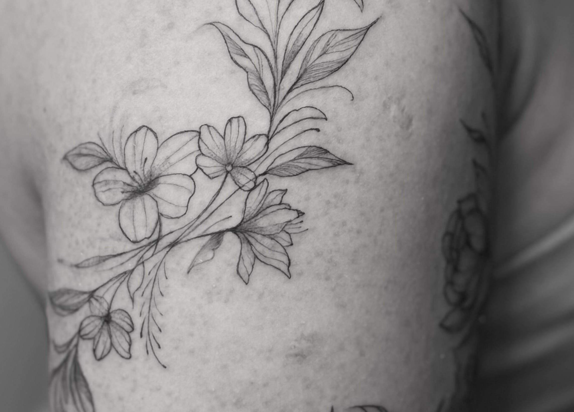 Elegant floral tattoo design at Nataly at Meadow & Charm - Council Bluffs, Iowa, US.