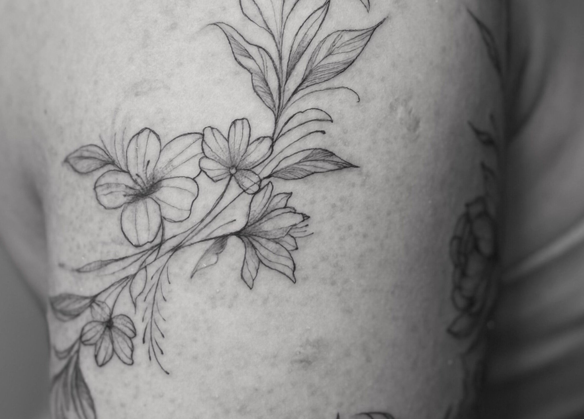 Elegant floral tattoo design at Nataly at Meadow & Charm - Council Bluffs, Iowa, US.