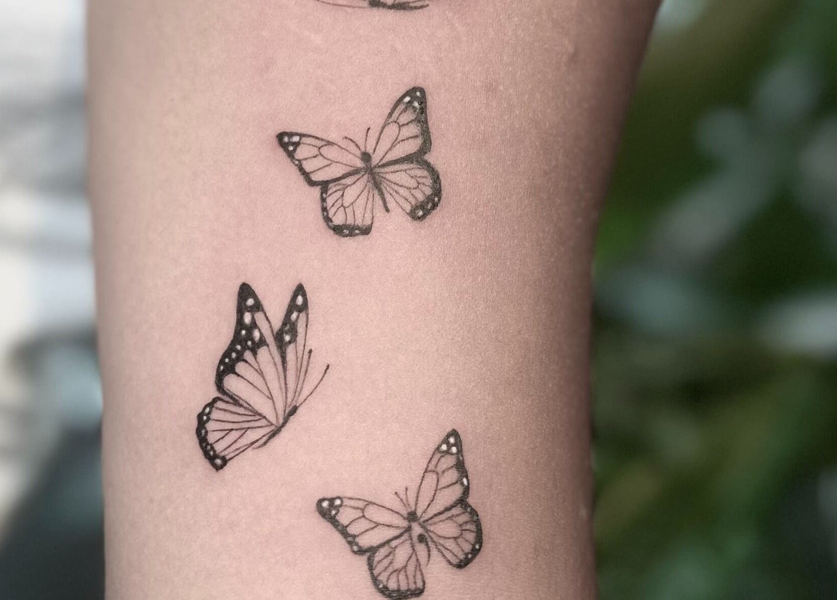 Butterfly tattoos on arm at Nataly at Meadow & Charm - Council Bluffs in Council Bluffs, Iowa, US.