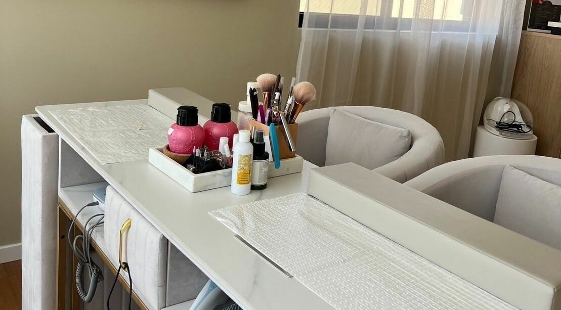 Chic beauty station at Queen Bee Aesthetic, Robertson, Queensland, AU, featuring elegant seating and nail care essentials.