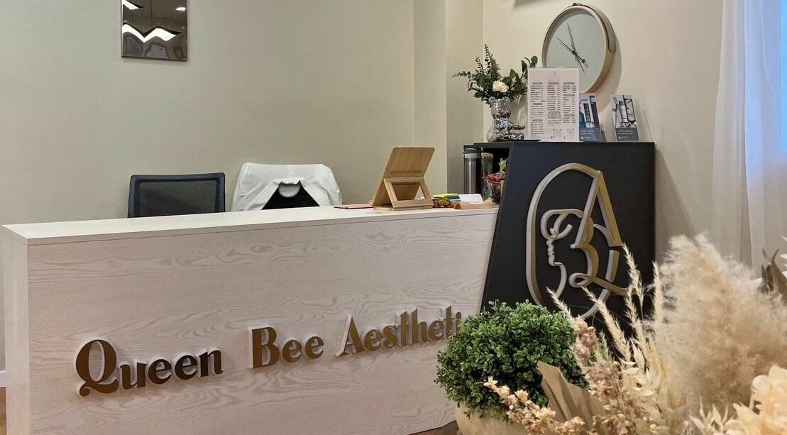 Stylish reception desk at Queen Bee Aesthetic, Robertson, Queensland, AU with elegant decor and signage.