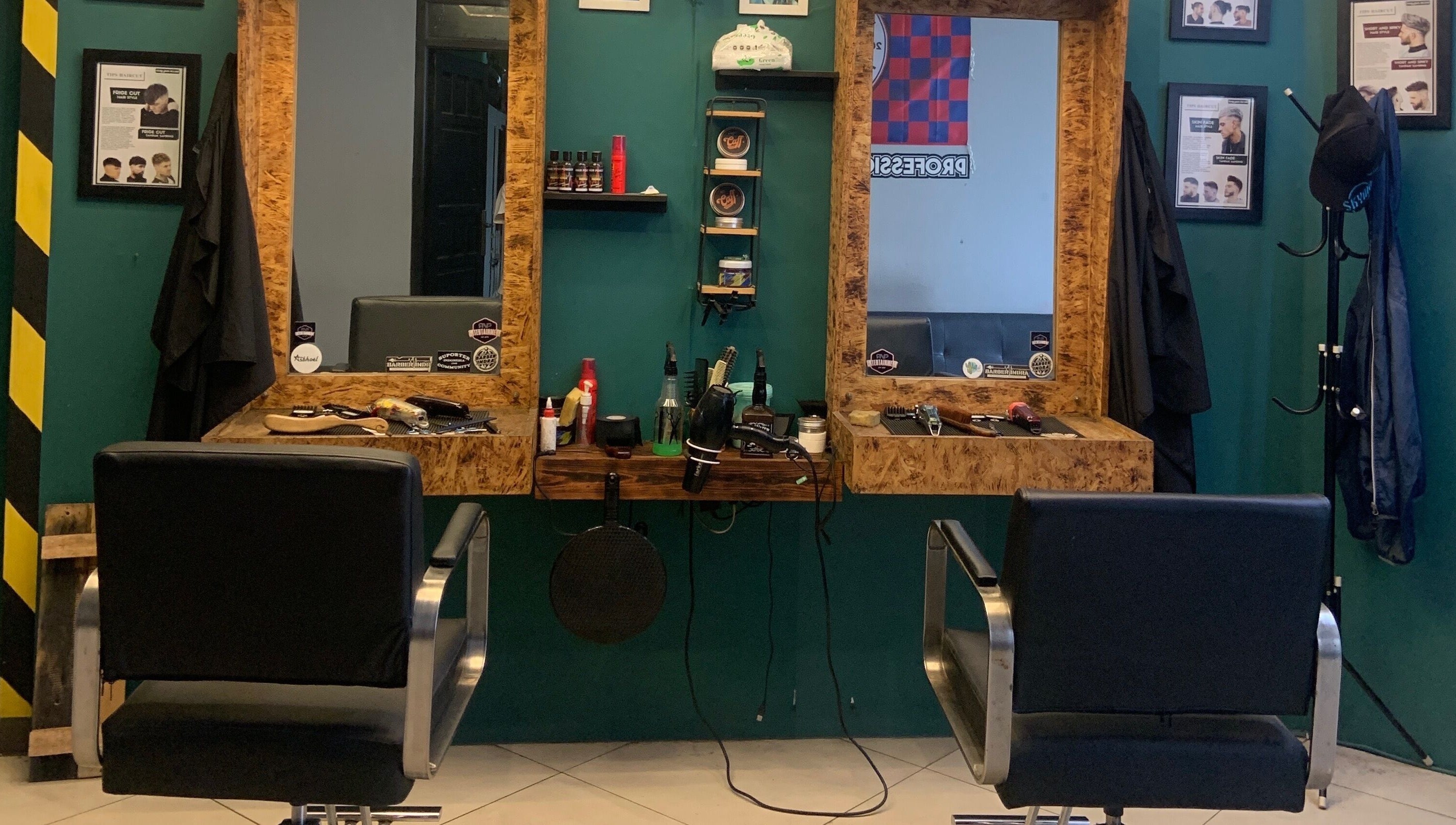 Modern cutting station at Indra Barbershop, Jawa Barat, Jawa Barat, ID with sleek black chairs and grooming tools.