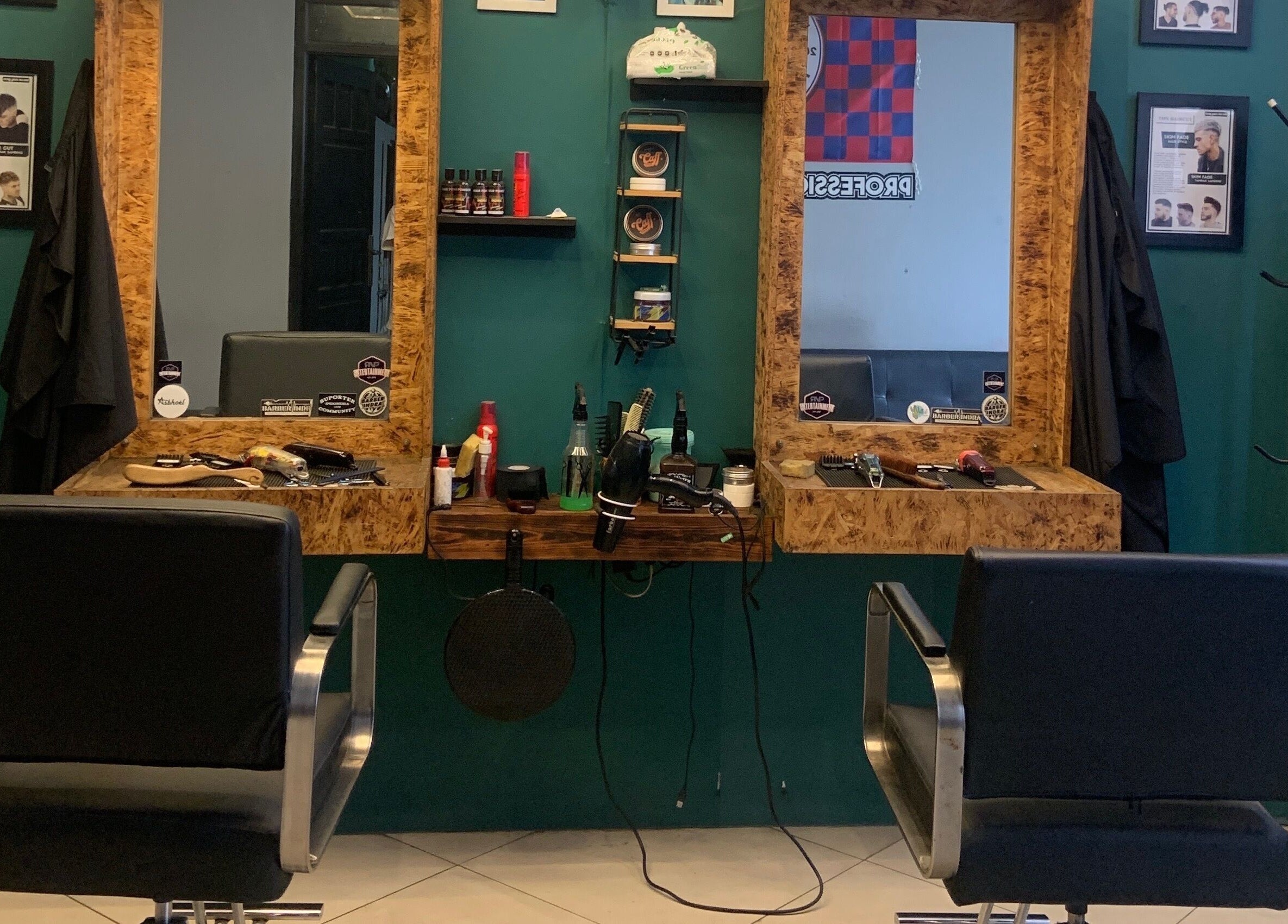 Modern cutting station at Indra Barbershop, Jawa Barat, Jawa Barat, ID with sleek black chairs and grooming tools.