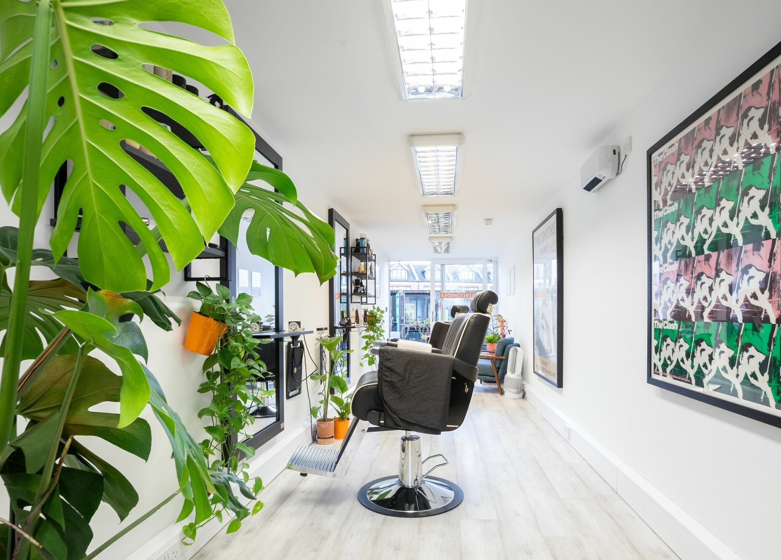 Sawyer salon in London, England, GB, with lush plants and stylish decor creating a serene ambiance.