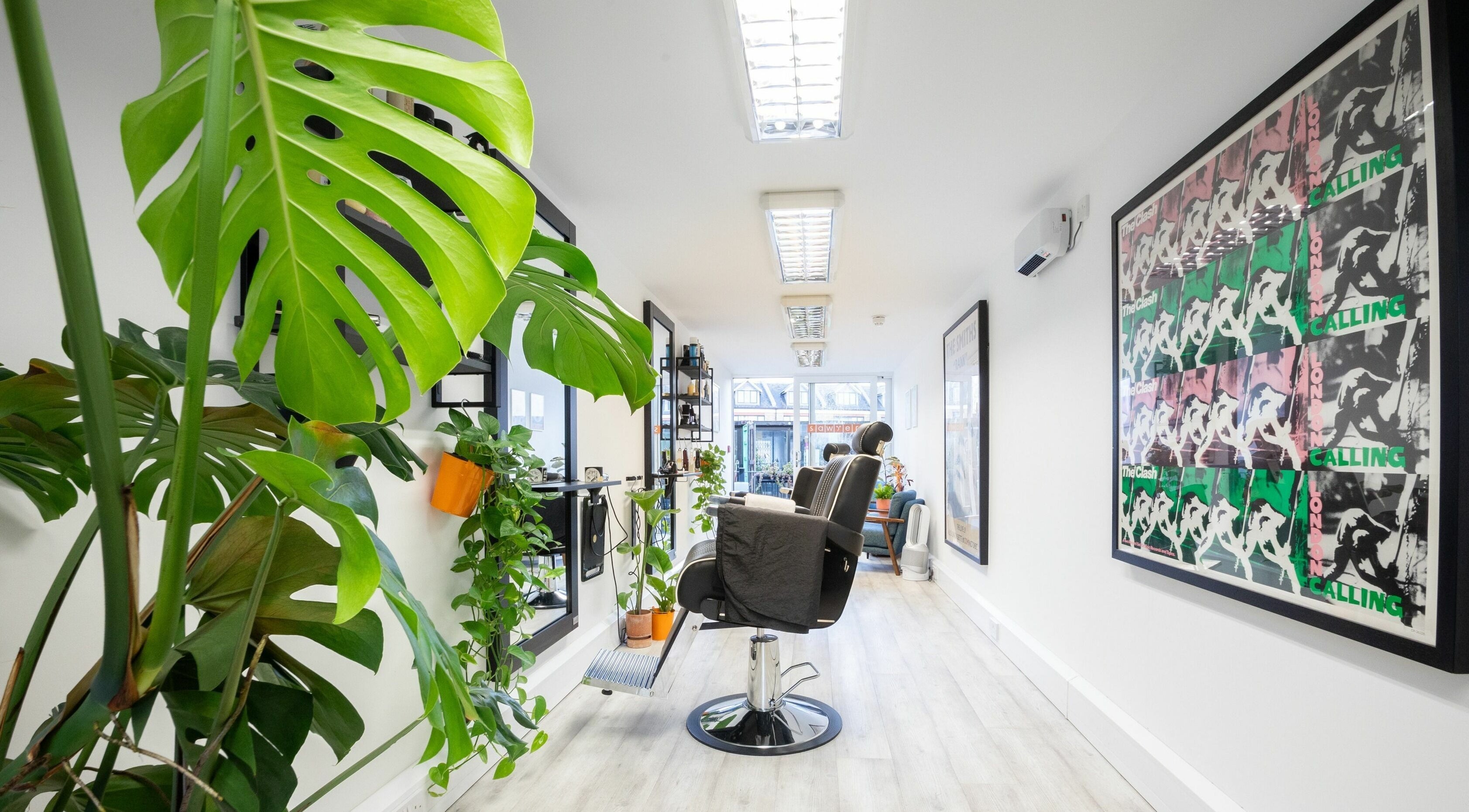 Sawyer salon in London, England, GB, with lush plants and stylish decor creating a serene ambiance.