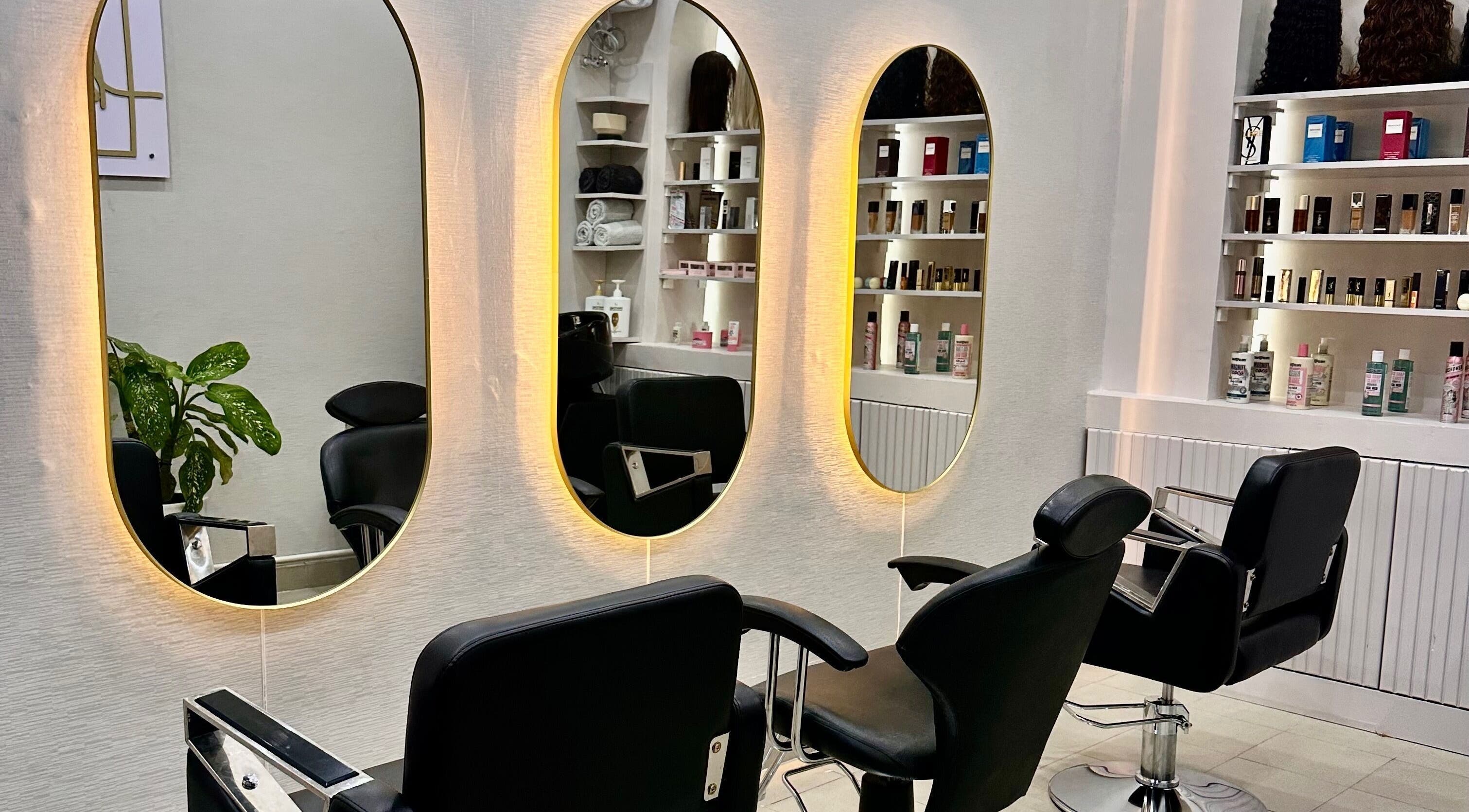Modern salon chairs and mirrors at Baddie Hair & Beauty in Kampala, Central Region, UG, showcasing elegance.