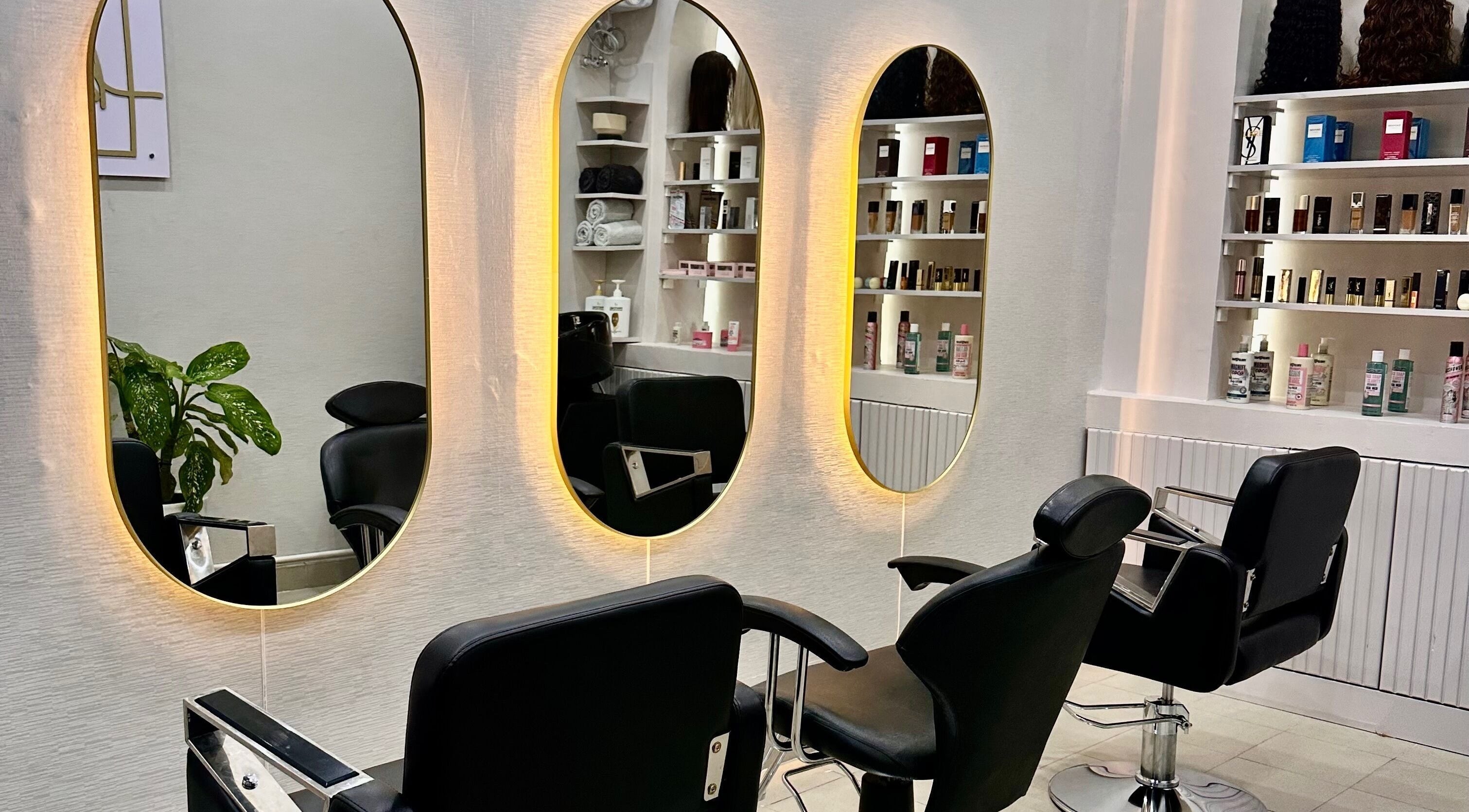 Modern salon chairs and mirrors at Baddie Hair & Beauty in Kampala, Central Region, UG, showcasing elegance.