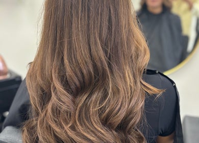 Glossy brown hair styled at Obsessed Hair and Beauty, Falkirk, Stirlingshire, GB, showcasing premium styling.