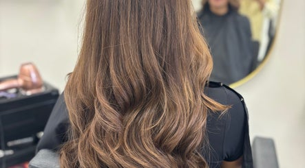 Glossy brown hair styled at Obsessed Hair and Beauty, Falkirk, Stirlingshire, GB, showcasing premium styling.