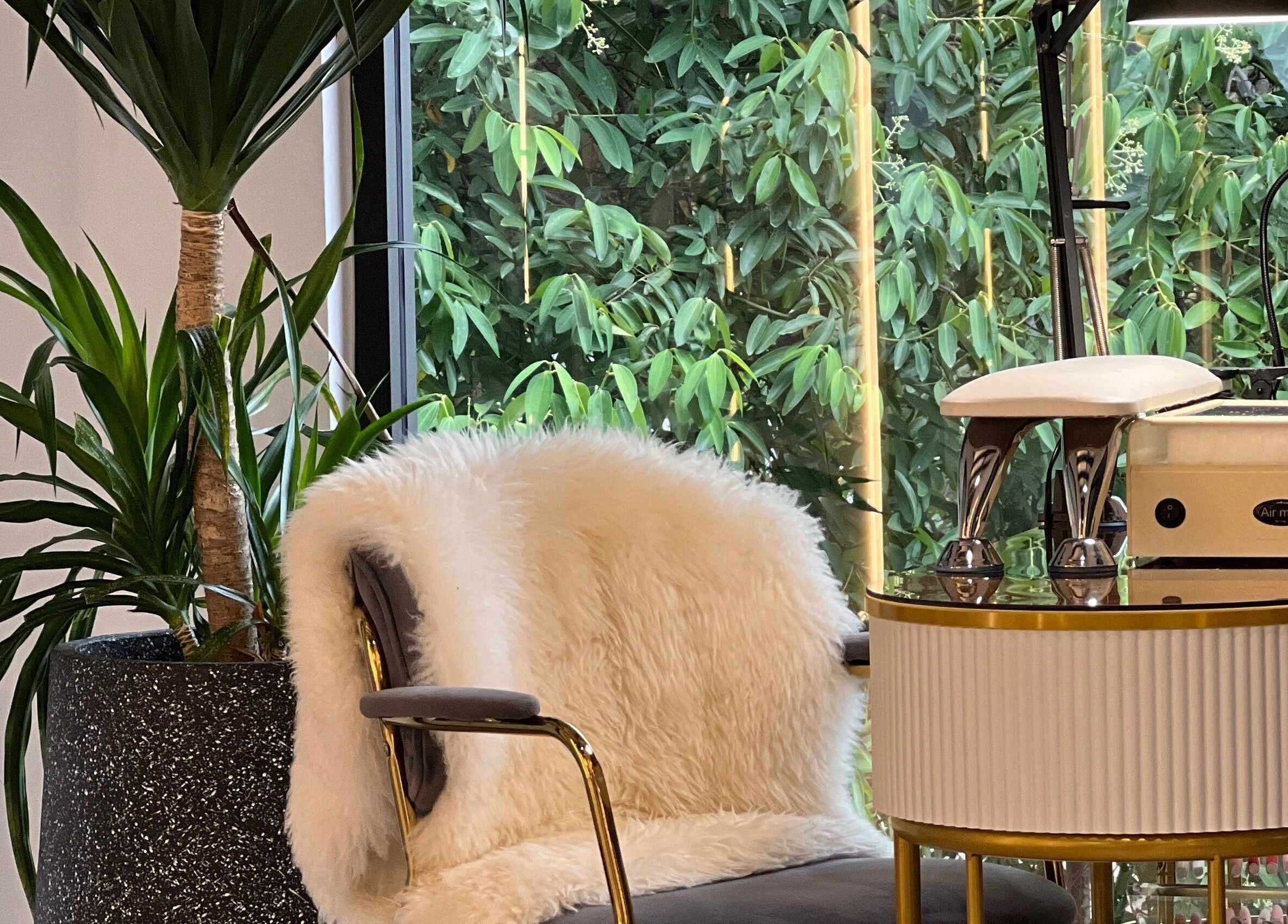 Cozy spa chair with plush fur at Browserie, Petaling Jaya, Selangor, MY, surrounded by lush greenery.