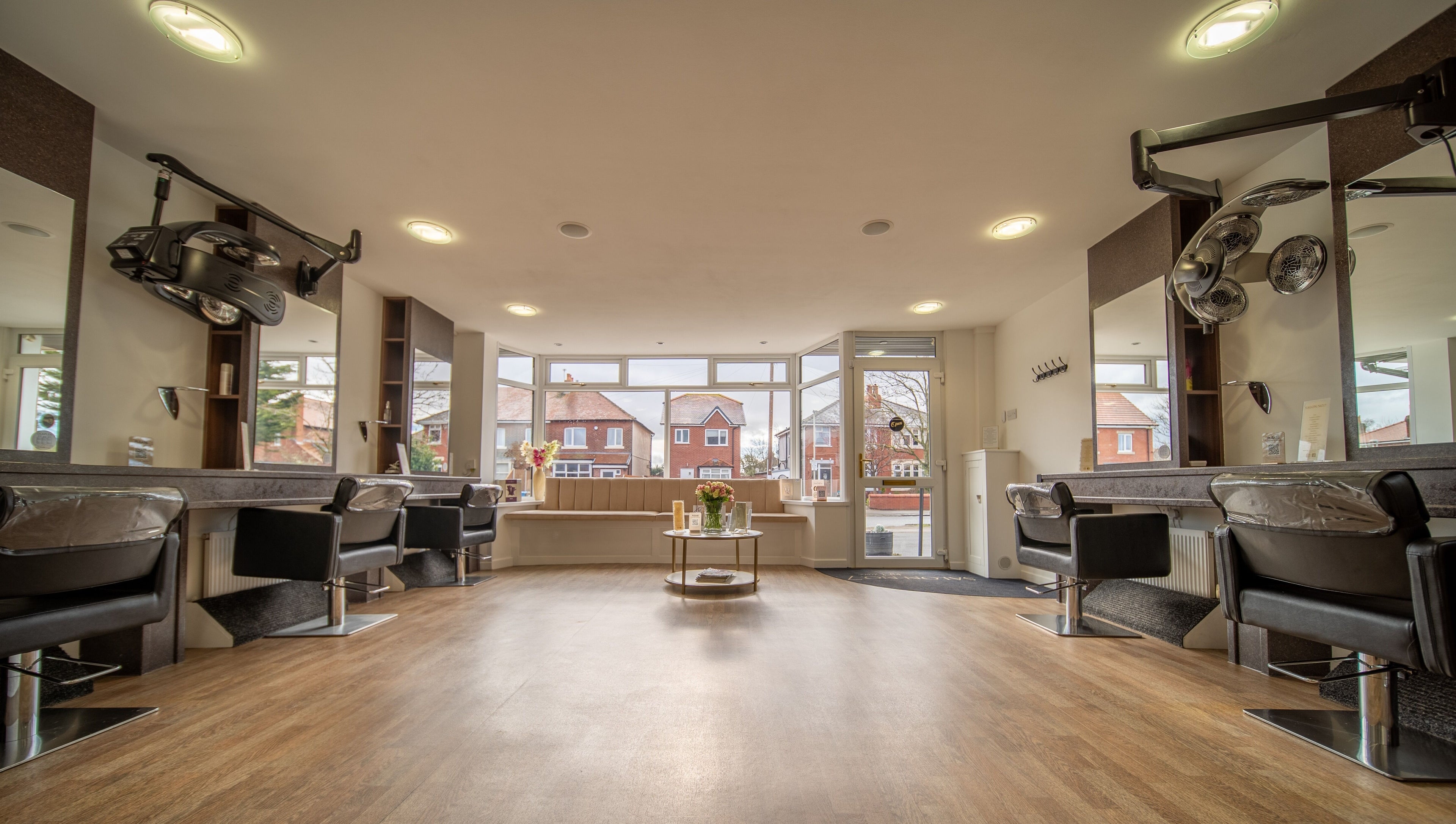 Modern salon interior at Salon No.7, Lytham St Annes, England, GB, featuring elegant styling stations and decor.