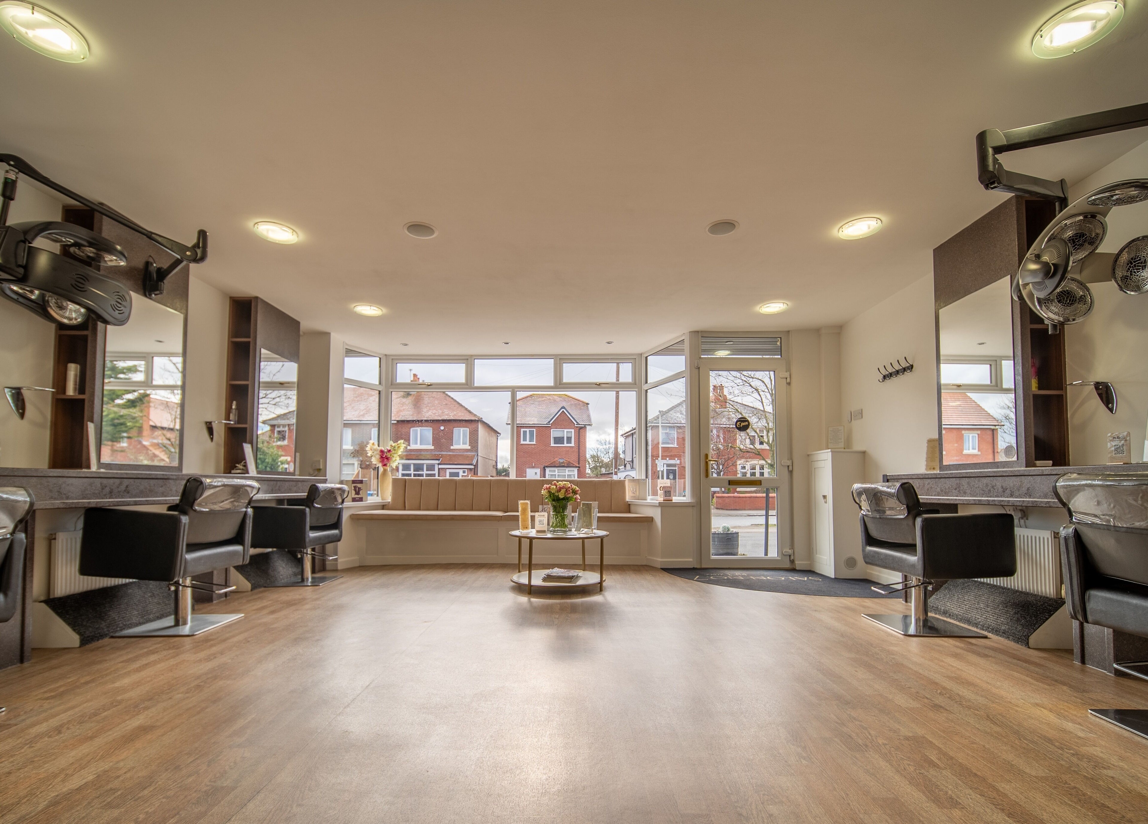 Modern salon interior at Salon No.7, Lytham St Annes, England, GB, featuring elegant styling stations and decor.