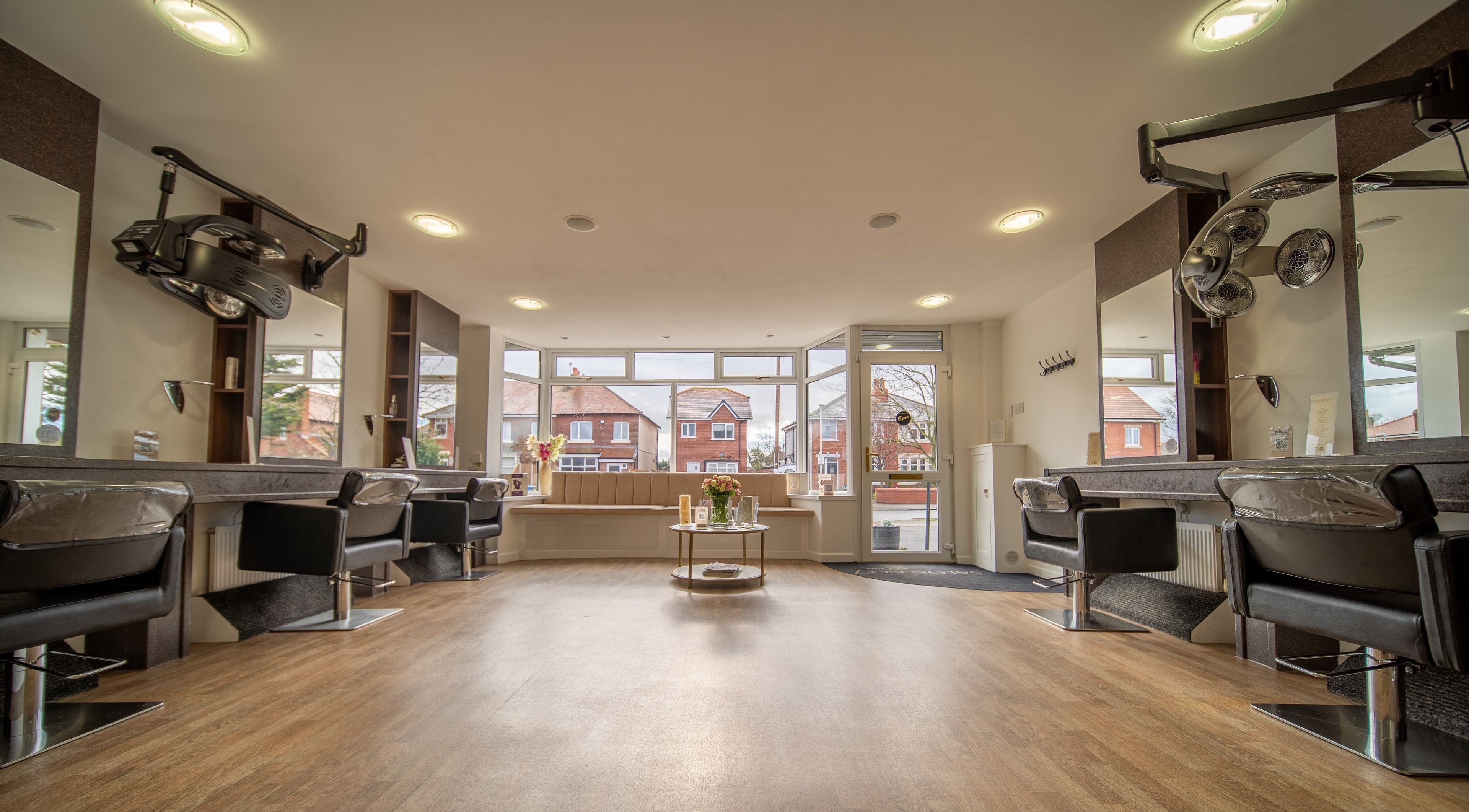 Modern salon interior at Salon No.7, Lytham St Annes, England, GB, featuring elegant styling stations and decor.